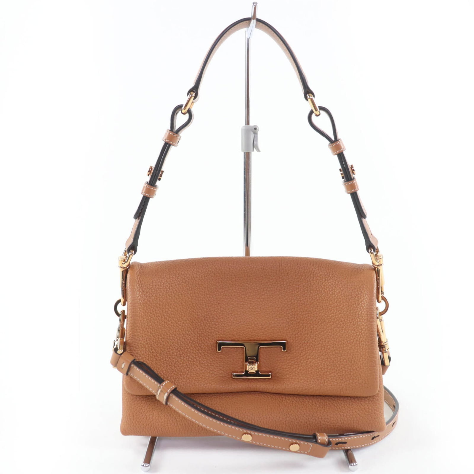 Shoulder bag leather by Tod's: Shoulder bag leather by Tod's Tod's Country of Origin: Italy, Material: Leather, Color: Brown. This shoulder bag features a turn lock closure and an inner card holder for added convenience. With its c