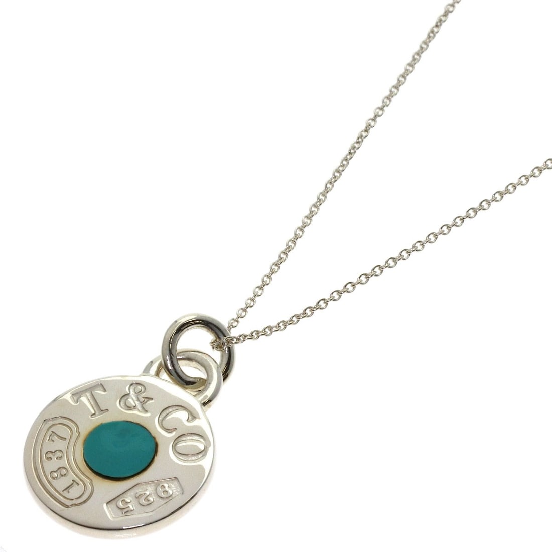 Silver Enamel Circle Necklace by Tiffany & Co 1837: Silver Enamel Circle Necklace by Tiffany & Co 1837 Silver Enamel Circle Necklace by Tiffany & Co features a striking silver circle design, showcasing the renowned brand's craftsmanship. This elegant