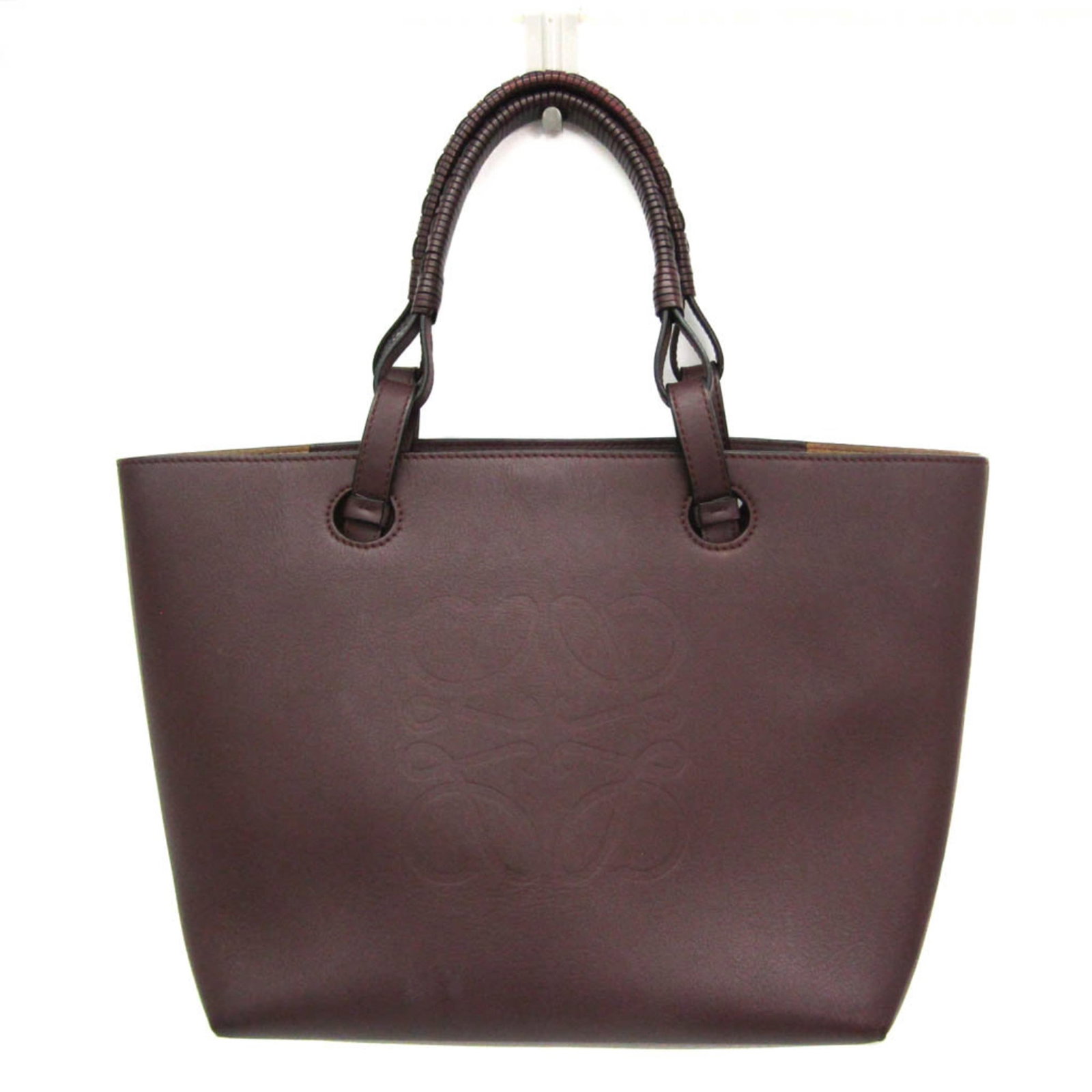 Handbag tote bag leather from Loewe: Handbag tote bag leather from Loewe Wine-colored leather tote bag from renowned Spanish luxury brand Loewe, measuring 24.5cm x 28cm x 14cm and weighing 720g. This stylish handbag features high-quality