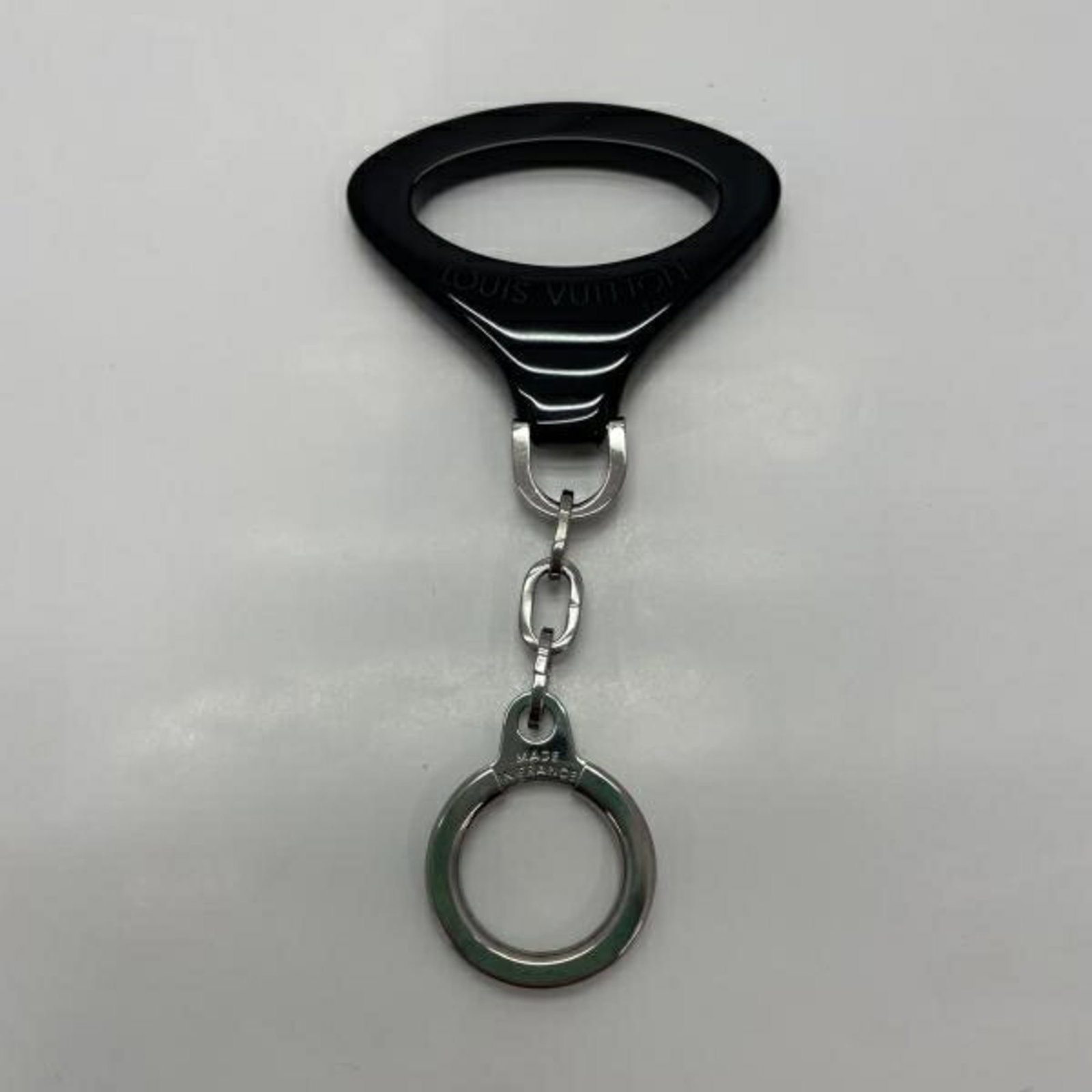 Louis Vuitton Key Chain: Louis Vuitton Key Chain Black Epi key chain from Louis Vuitton. A sleek and understated accessory, this key chain bears the iconic signature of the renowned brand. Made from high-quality materials, it