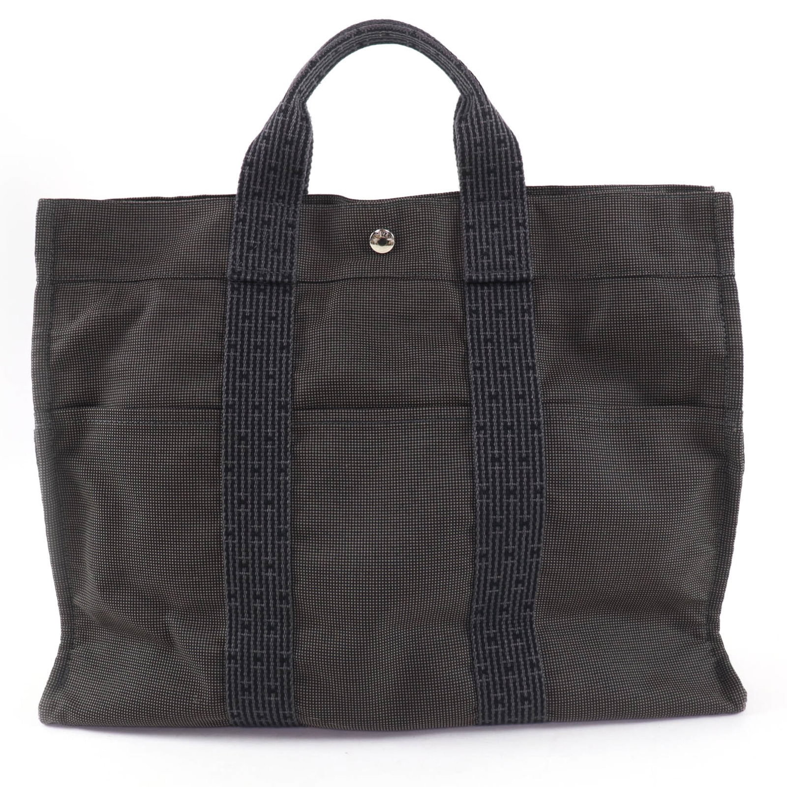 Polyester Polyamide Hermes Tote: Polyester Polyamide Hermes Tote Polyester Polyamide Hermes Tote features a sleek gray color and silver hardware, with a zipper closure and sturdy handle. Made from high-quality polyamide and polyester