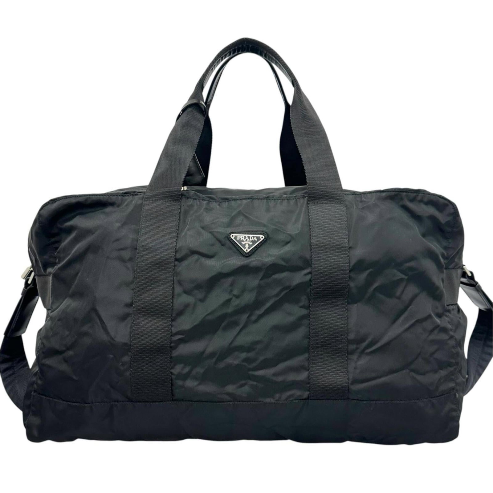 Nylon bag Boston by Prada: Nylon bag Boston by Prada Nylon bag Boston by Prada, made from high-quality nylon material, features a sleek black design with dimensions of 24cm x 51cm x 42cm. This stylish bag is crafted in Italy an