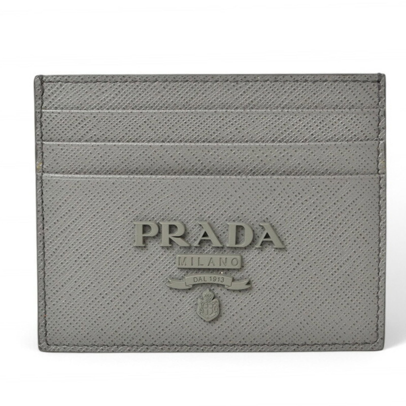 Card Case Saffiano by Prada: Card Case Saffiano by Prada Saffiano by Prada Card Case - A sleek and sophisticated accessory in light gray. Made from the renowned Saffiano material, this card case boasts a compact size of 8cm x 10c