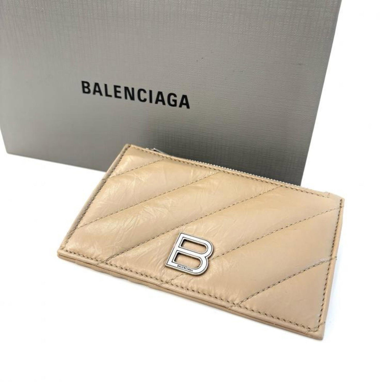 Card Case By Balenciaga: Card Case By Balenciaga Balenciaga card case in beige, measuring 8.5cm x 13cm x 1cm, offering a compact storage solution for personal cards and essentials. The simple design provides a sleek finish to