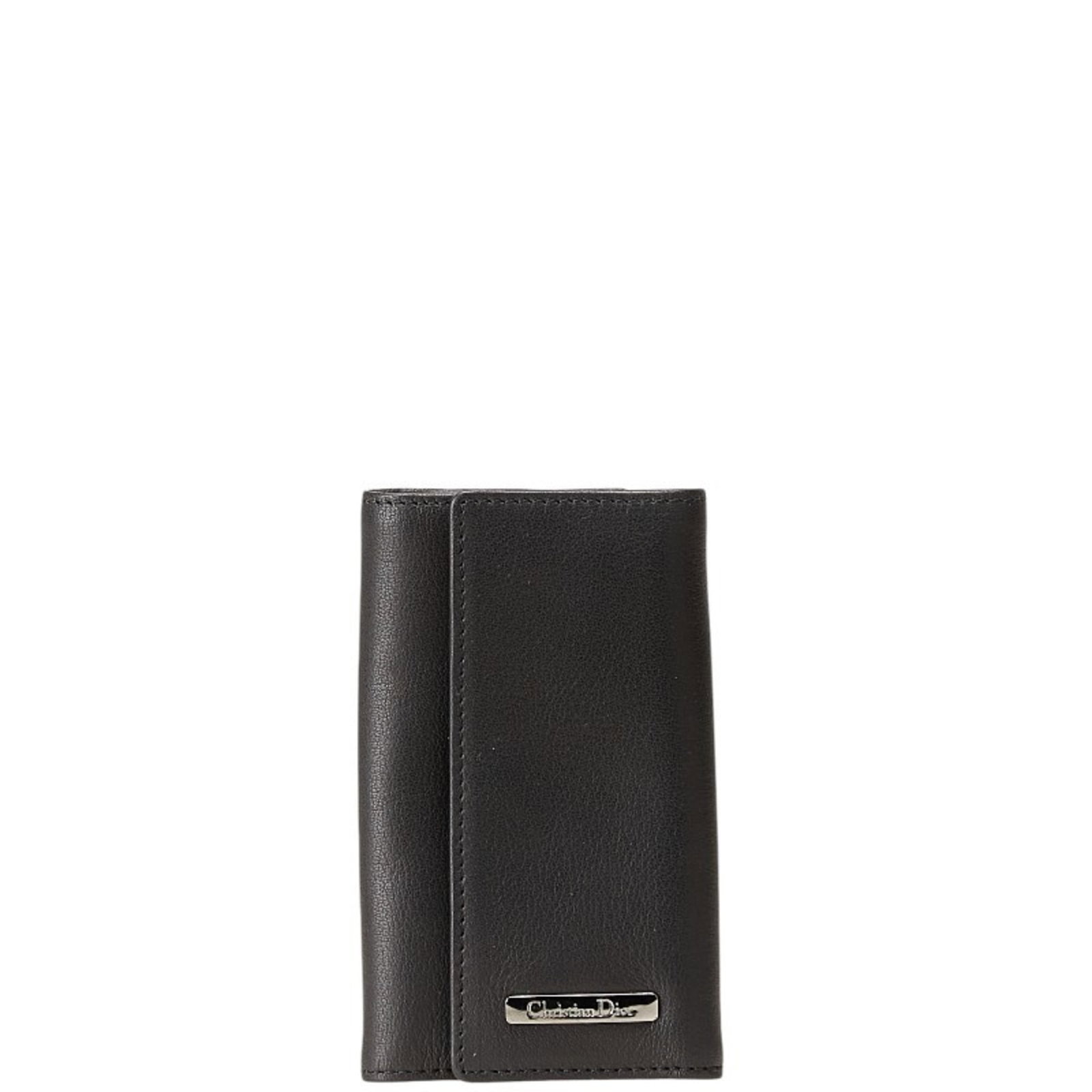 Christian Dior Keycase Leather: Christian Dior Keycase Leather Black leather keycase with dimensions 11cm x 6.5cm x 1cm, made from Christian Dior material. This small leather case bears a signature and is available for purchase in i