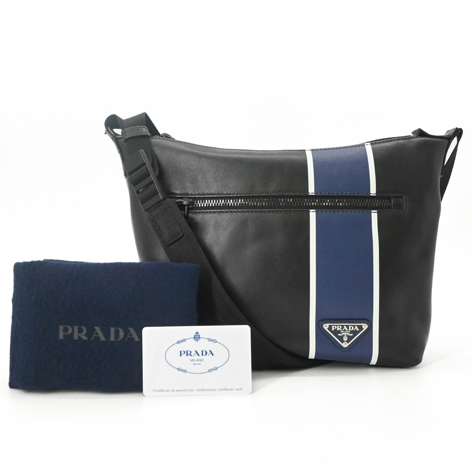 Prada Shoulder Bag Leather: Prada Shoulder Bag Leather The Prada Shoulder Bag Leather features sleek, black leather and elegant blue accents. Measuring 21cm x 24cm x 6cm, it offers a compact yet stylish design. Made from high-qu