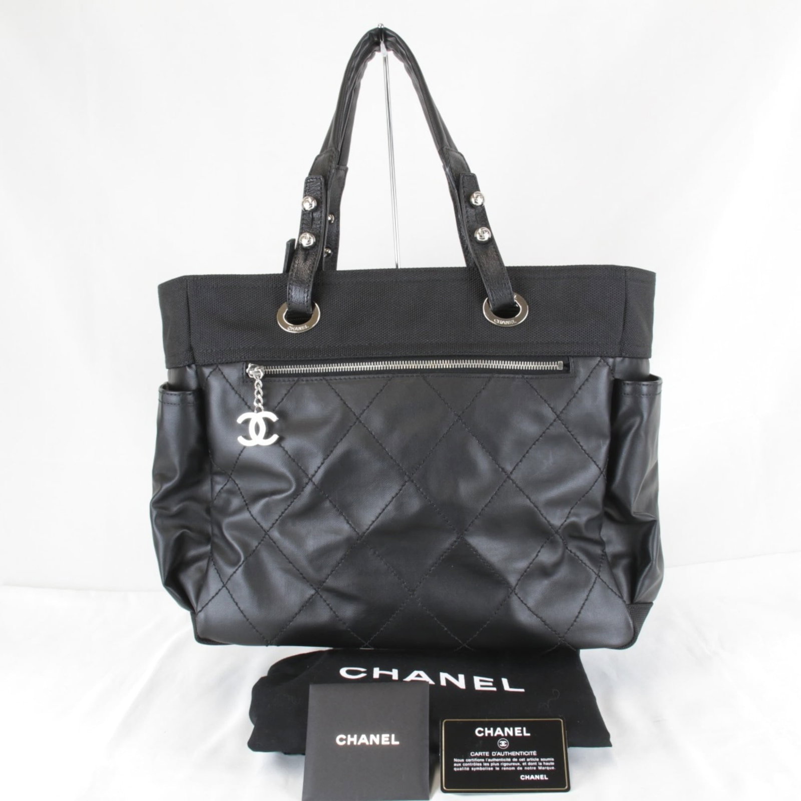 Canvas Pvc Tote Bag Chanel: Canvas Pvc Tote Bag Chanel Canvas PVC Tote Bag by Chanel. This black canvas and PVC tote bag features a classic design with a durable PVC material, making it both stylish and practical. Measuring
