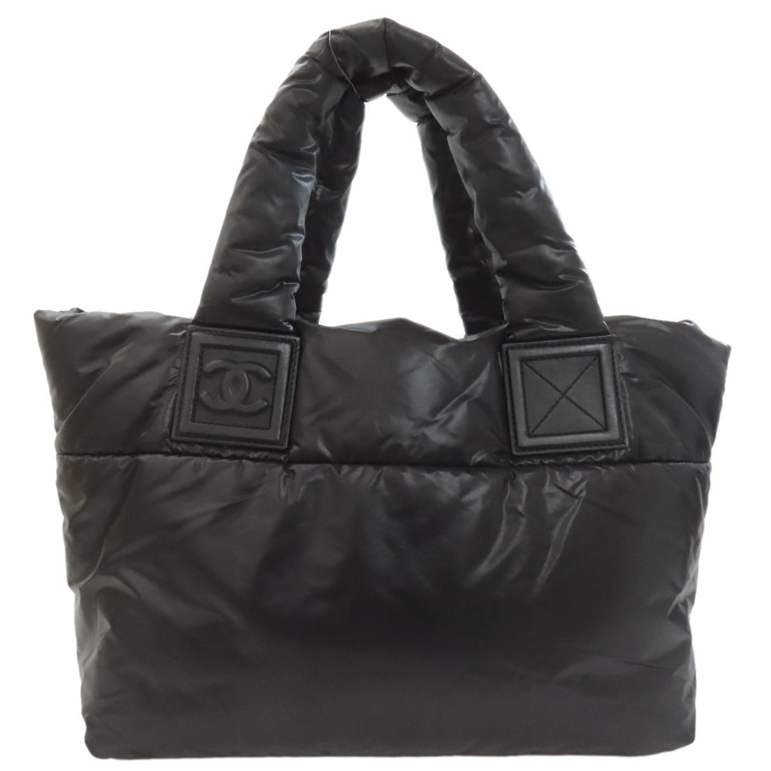 Cococoon Tote Bag By Nylon: Cococoon Tote Bag By Nylon Black Nylon Tote Bag with CHANEL Style. Made from high-quality nylon, this tote bag features the iconic CHANEL style in black. The sleek design makes it a practical and styl