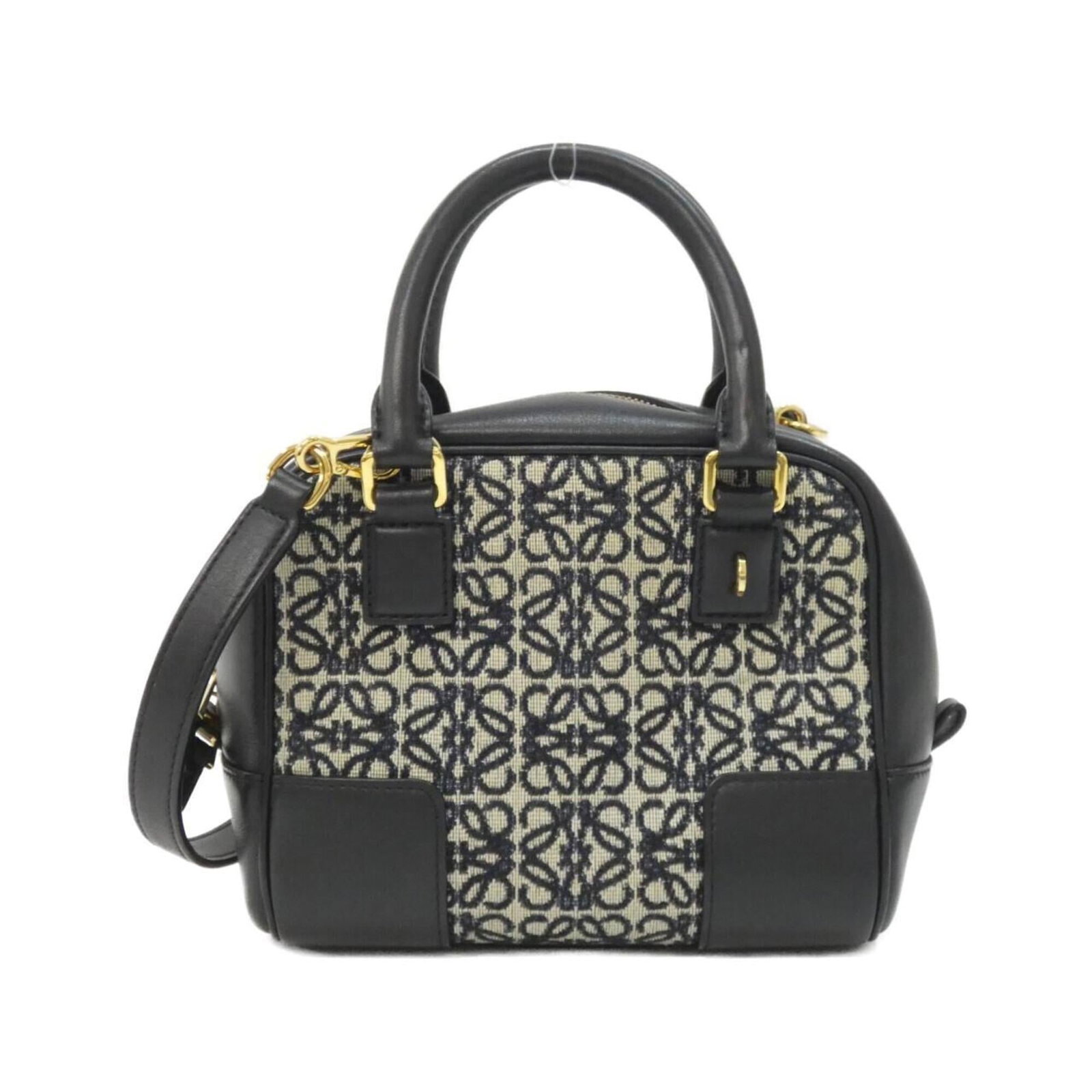 Loewe Handbag Canvas Leather: Loewe Handbag Canvas Leather Canvas and leather come together in the Loewe Amazona handbag, featuring calfskin details and gold hardware. The black and navy color options provide a versatile choice fo