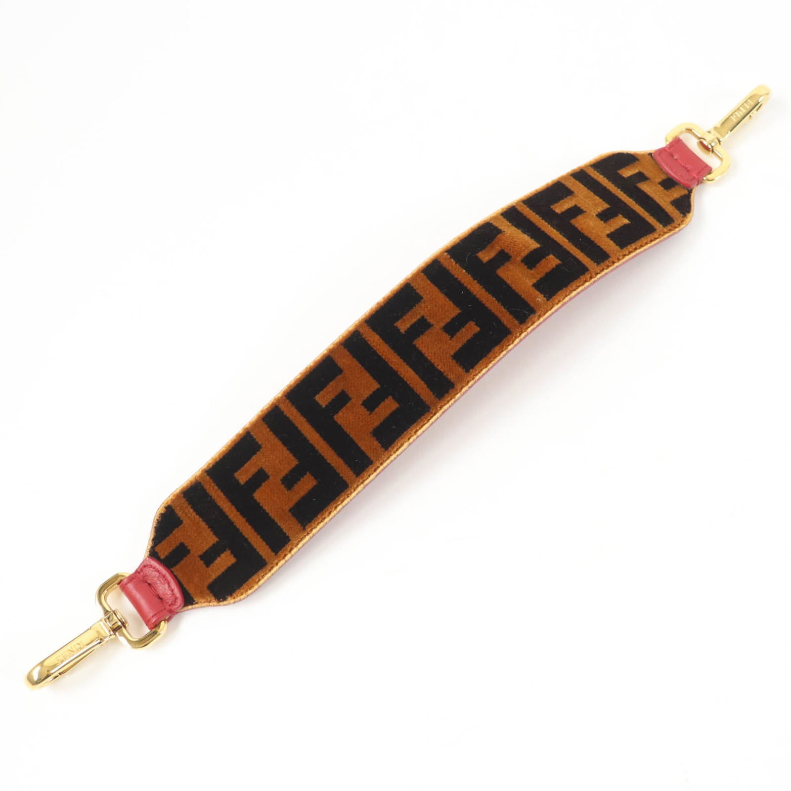 Fendi Strap Velvet: Fendi Strap Velvet This Fendi Strap Velvet features rich brown and red color accents, crafted from luxurious velvet material. The strap measures 37cm in length, making it a stylish accessory for women