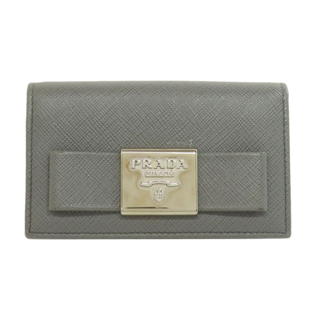 Fiocco Card Case by Prada Safiano: Fiocco Card Case by Prada Safiano The Fiocco Card Case by Prada Safiano boasts a sleek, gray exterior crafted from high-quality Safiano material. This stylish card case features a distinctive design t