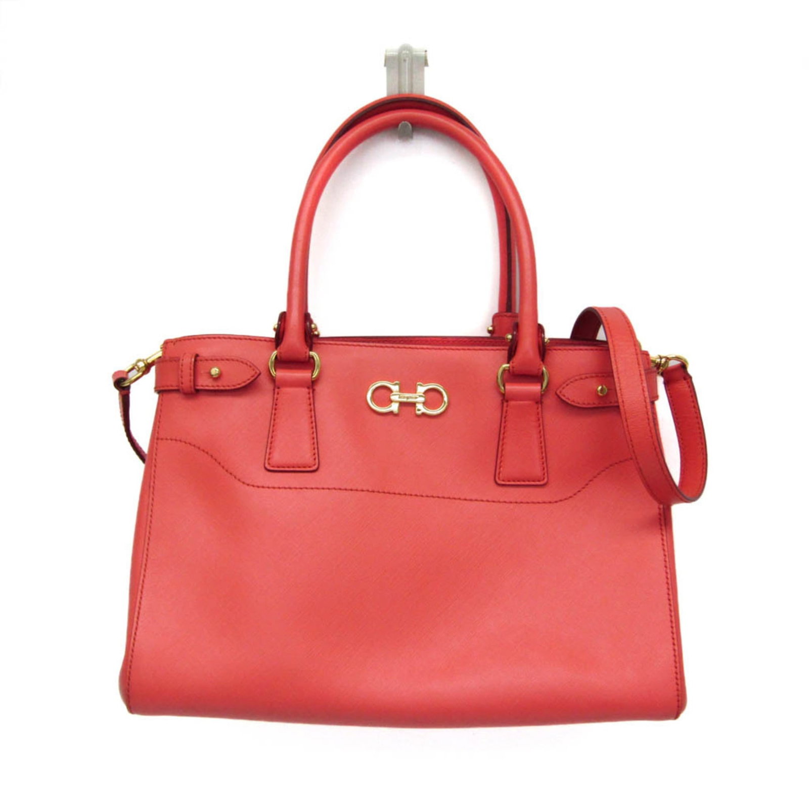 Salvatore Ferragamo leather handbag shoulder bag: Salvatore Ferragamo leather handbag shoulder bag Salvatore Ferragamo's iconic GG-21 design takes center stage in this stunning salmon pink leather shoulder bag. With its sleek open interior and two fu