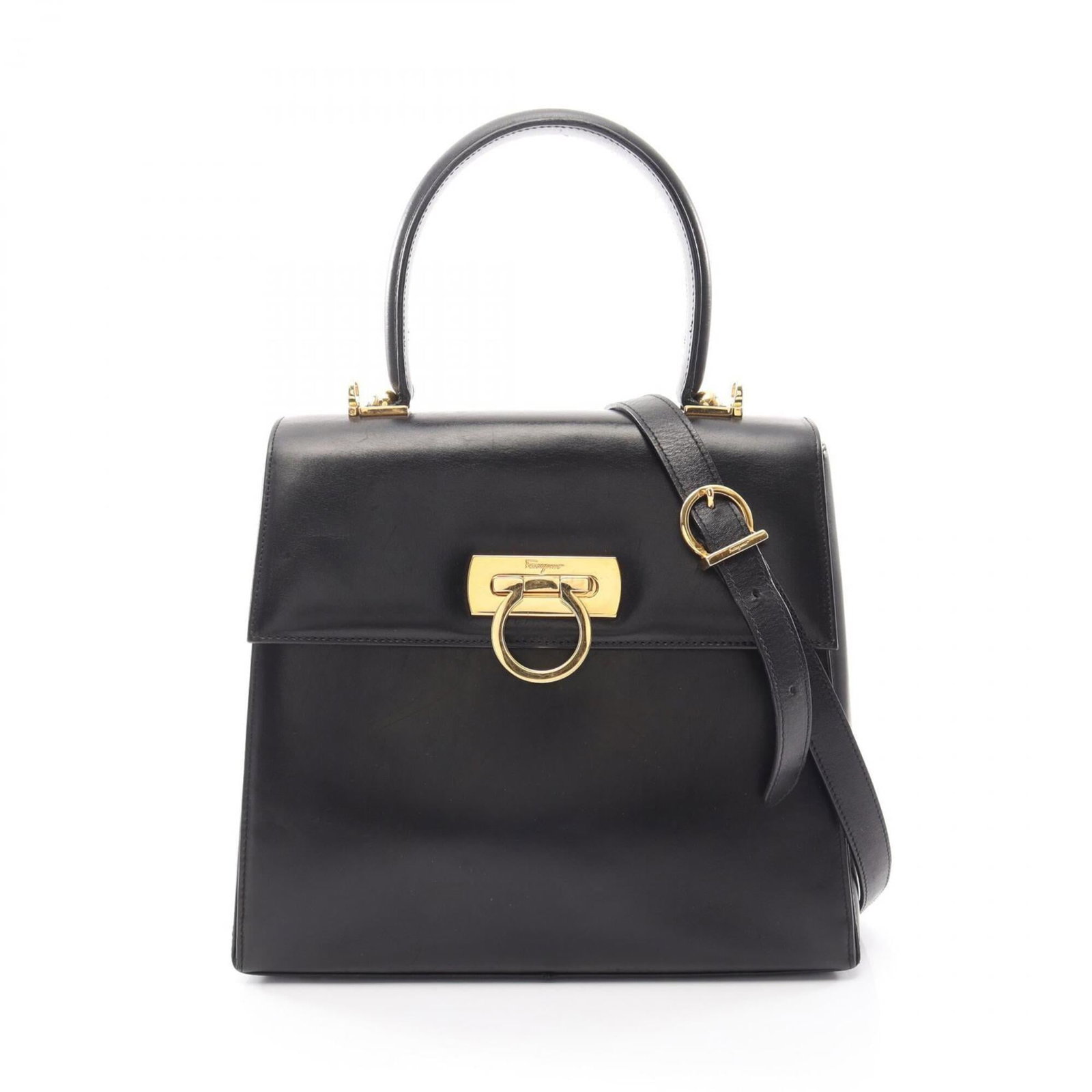 Handbag Leather Salvatore Ferragamo: Handbag Leather Salvatore Ferragamo This black leather handbag from Salvatore Ferragamo features clean lines and classic design, with dimensions that make it easy to carry. The bag's sleek shape and l
