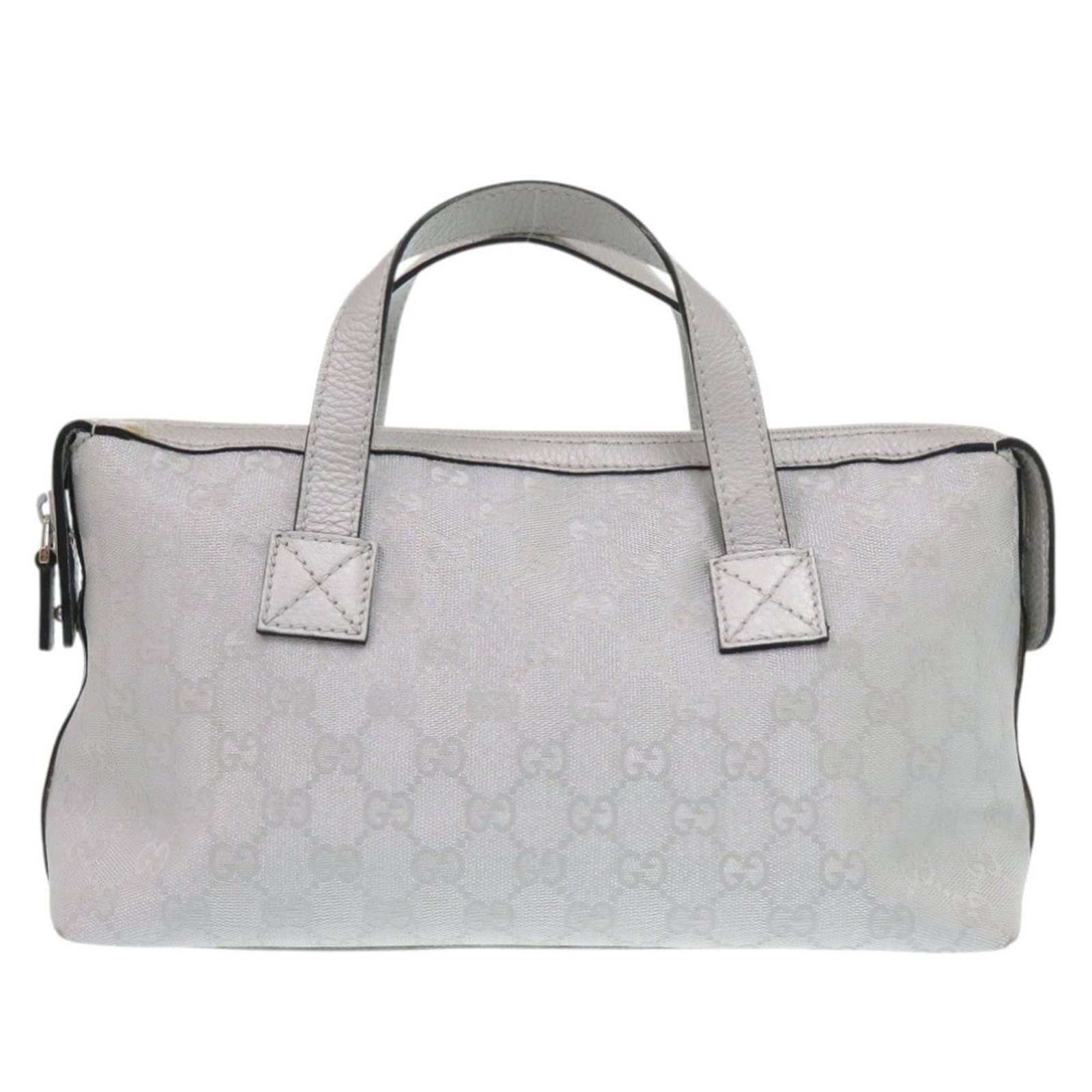 Gucci Canvas Leather Handbag: Gucci Canvas Leather Handbag GG Canvas Leather Handbag from Gucci features a striking silver color and sleek design, with a zipper closure and two pockets for added convenience. The bag's durable GG c