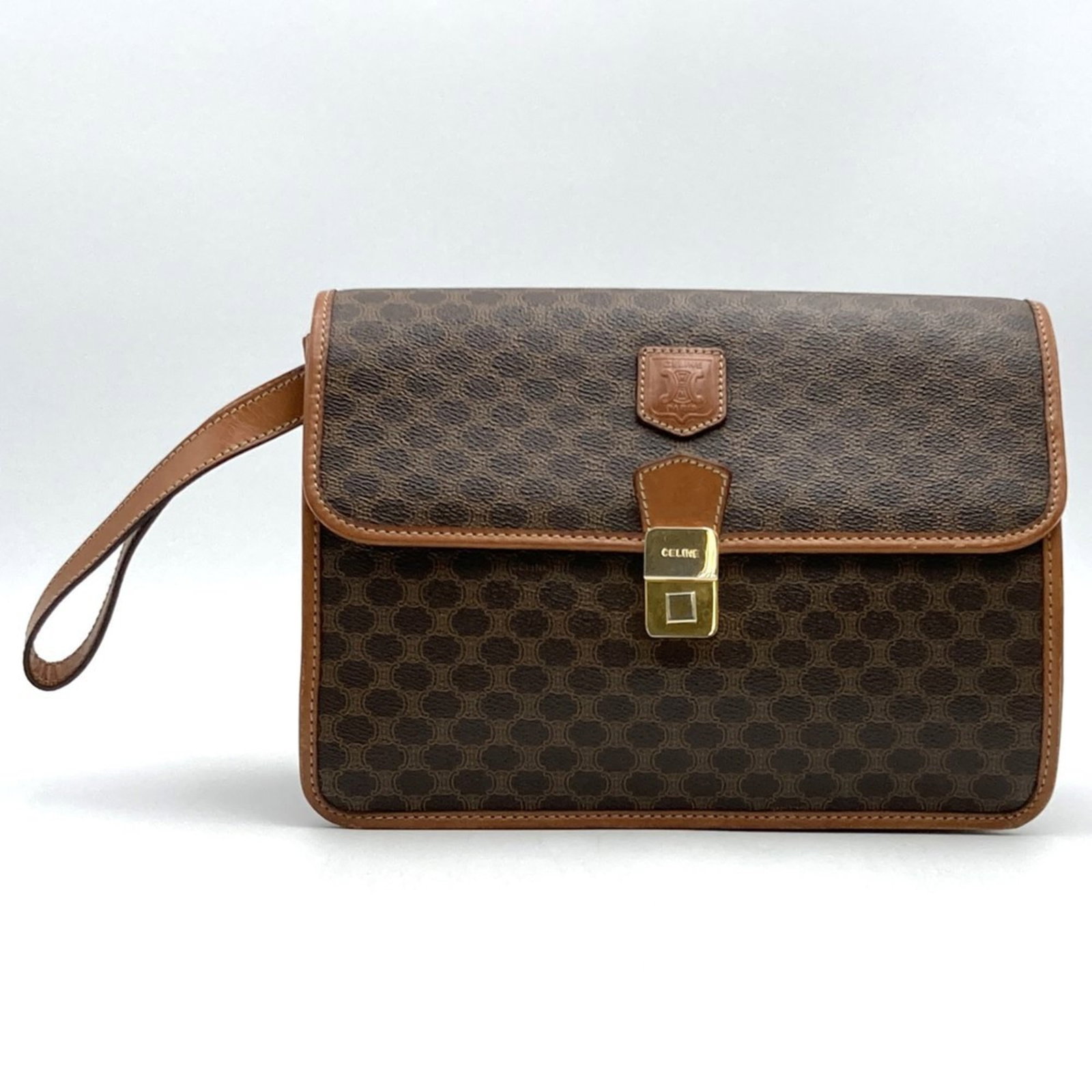 Celine Clutch Bag Pvc: Celine Clutch Bag Pvc Made from durable PVC, this Celine Macadam Clutch Bag boasts a sleek brown color and compact size. The bag's sturdy design and weighted construction make it easy to carry, with a