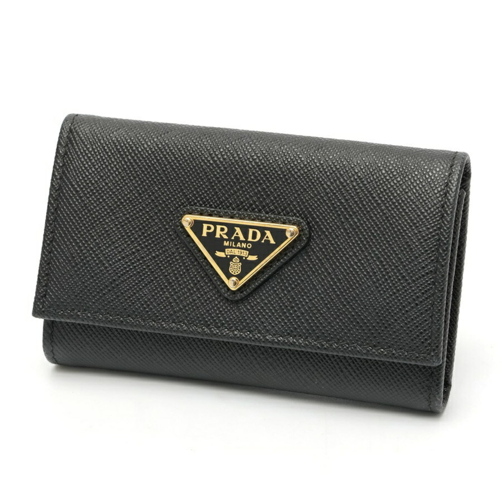 Keycase Leather by Prada: Keycase Leather by Prada Saffiano leather keycase from Prada, crafted with attention to detail and made in Italy. This sleek black keycase features four key hooks and a compact design that fits easily