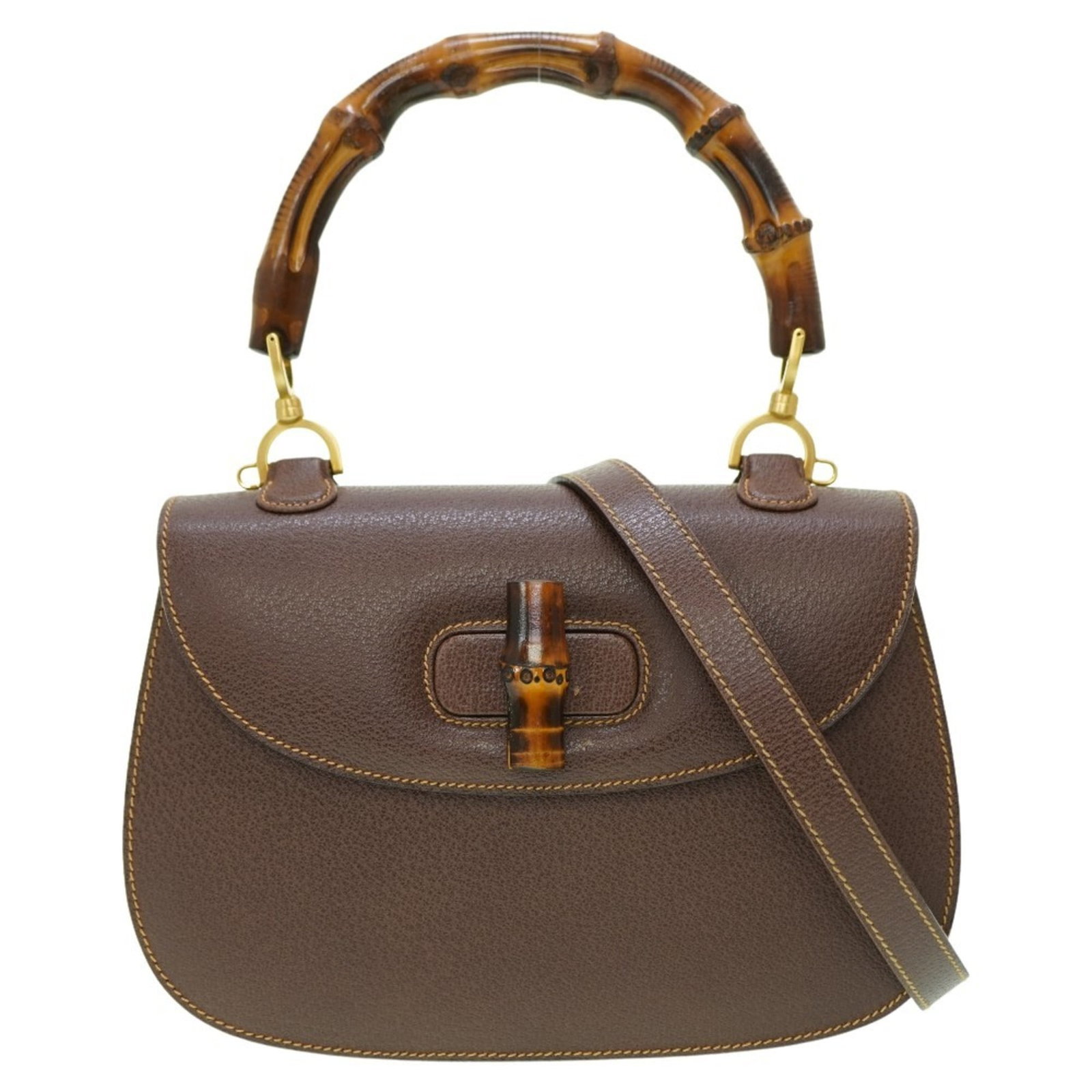 Handbag Leather Gucci: Handbag Leather Gucci Brown leather Gucci handbag with gold hardware, measuring 19cm x 27cm x 8.5cm and accompanied by a dust bag, mirror, and shoulder strap. This classic design features high-quality