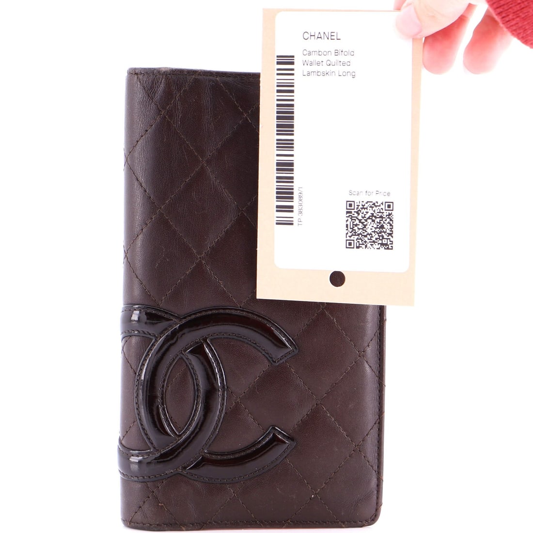 Long quilted lambskin wallet bifold Cambon from Chanel: Long quilted lambskin wallet bifold Cambon from Chanel Long quilted lambskin wallet bifold Cambon from Chanel features a classic design with a rich, brown exterior and contrasting orange interior. The
