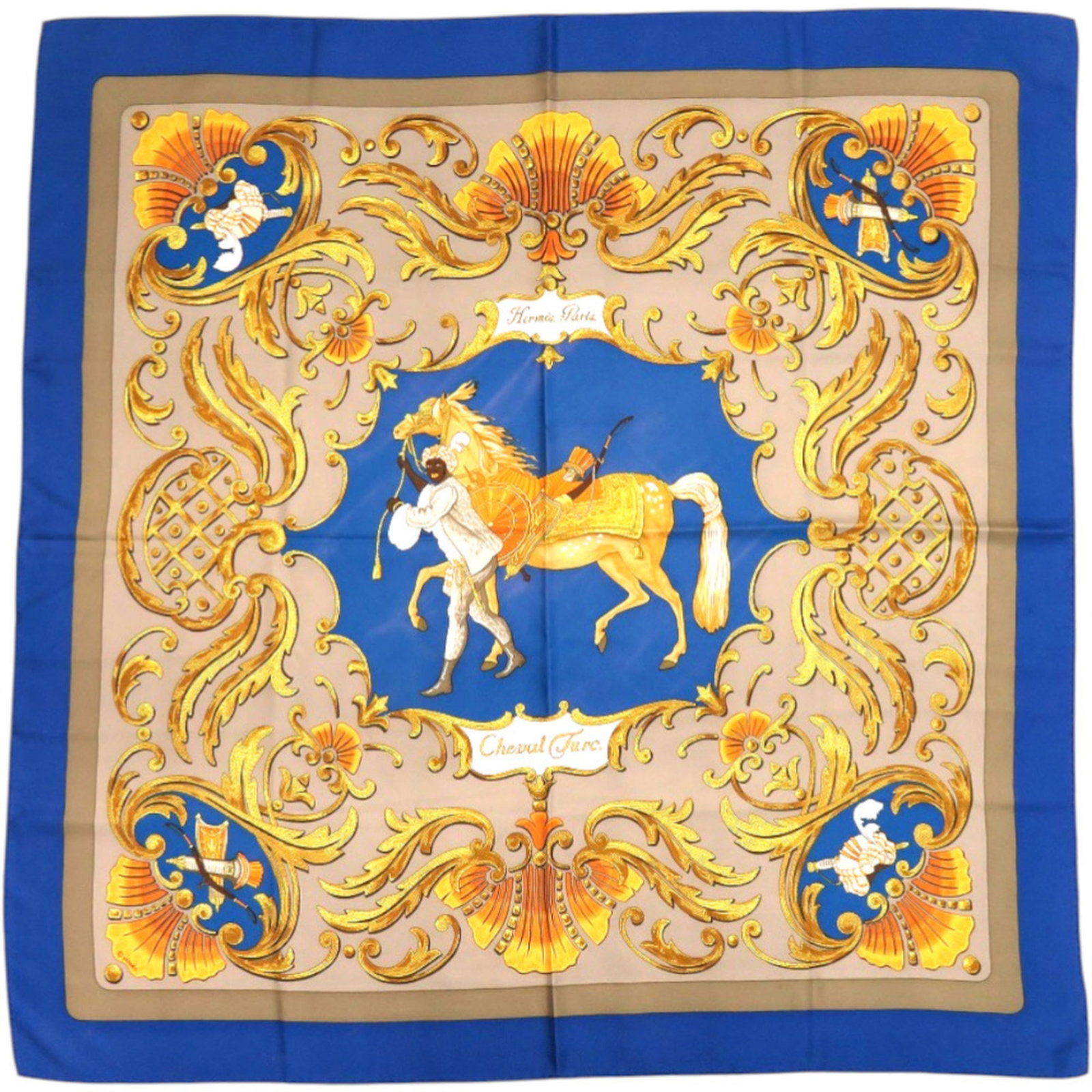 Hermes silk scarf: Hermes silk scarf Silk scarf from renowned French fashion house Hermes, crafted in Turkey. This beautiful piece features a stunning blue and gold color palette with subtle gray undertones, presented o