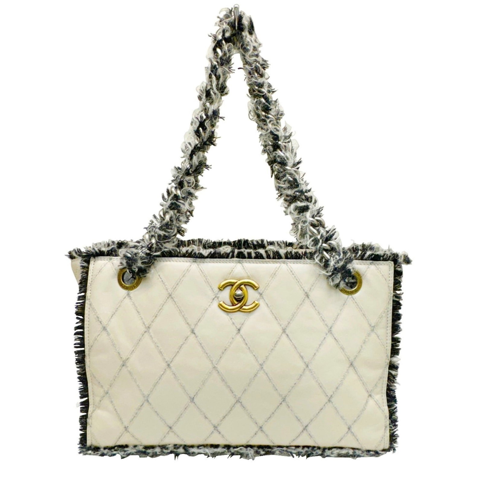 Tweed leather tote bag by Chanel: Tweed leather tote bag by Chanel Tweed leather tote bag by Chanel in beige and black, featuring a classic design with clean lines and a timeless aesthetic. The bag's tweed and leather materials provid