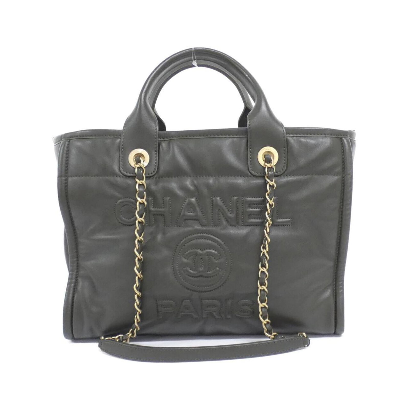 Chanel Handbag leather: Chanel Handbag leather Calfskin leather in khaki color, characteristic of the iconic Deauville handbag style from Chanel. This piece features matte gold hardware and a sturdy design, with a pouch acce