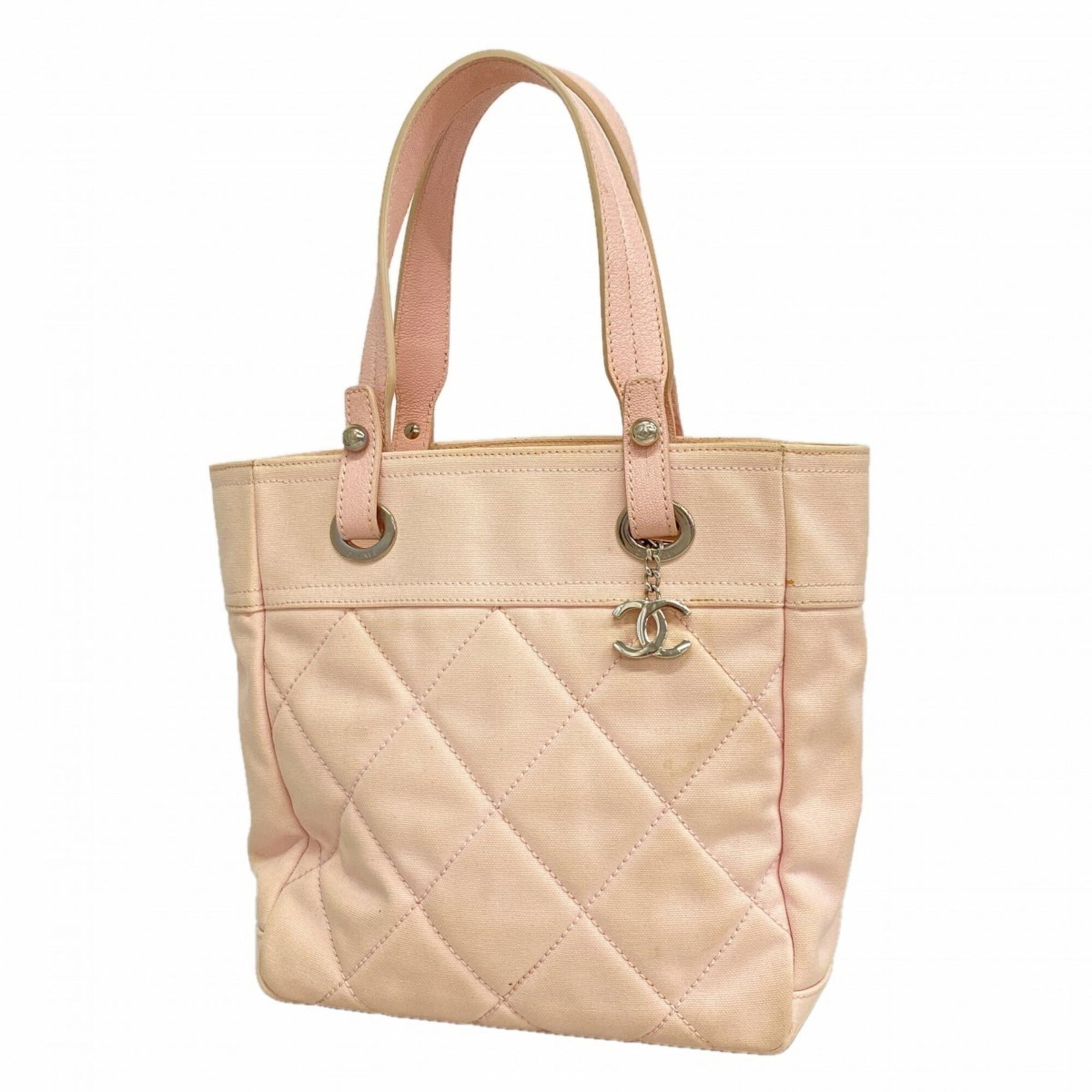 Canvas tote bag by Chanel: Canvas tote bag by Chanel Canvas tote bag by Chanel, featuring pink canvas and silver hardware, measures 28cm x 25cm x 10.5cm. This stylish tote boasts a classic design with clean lines and a timeless