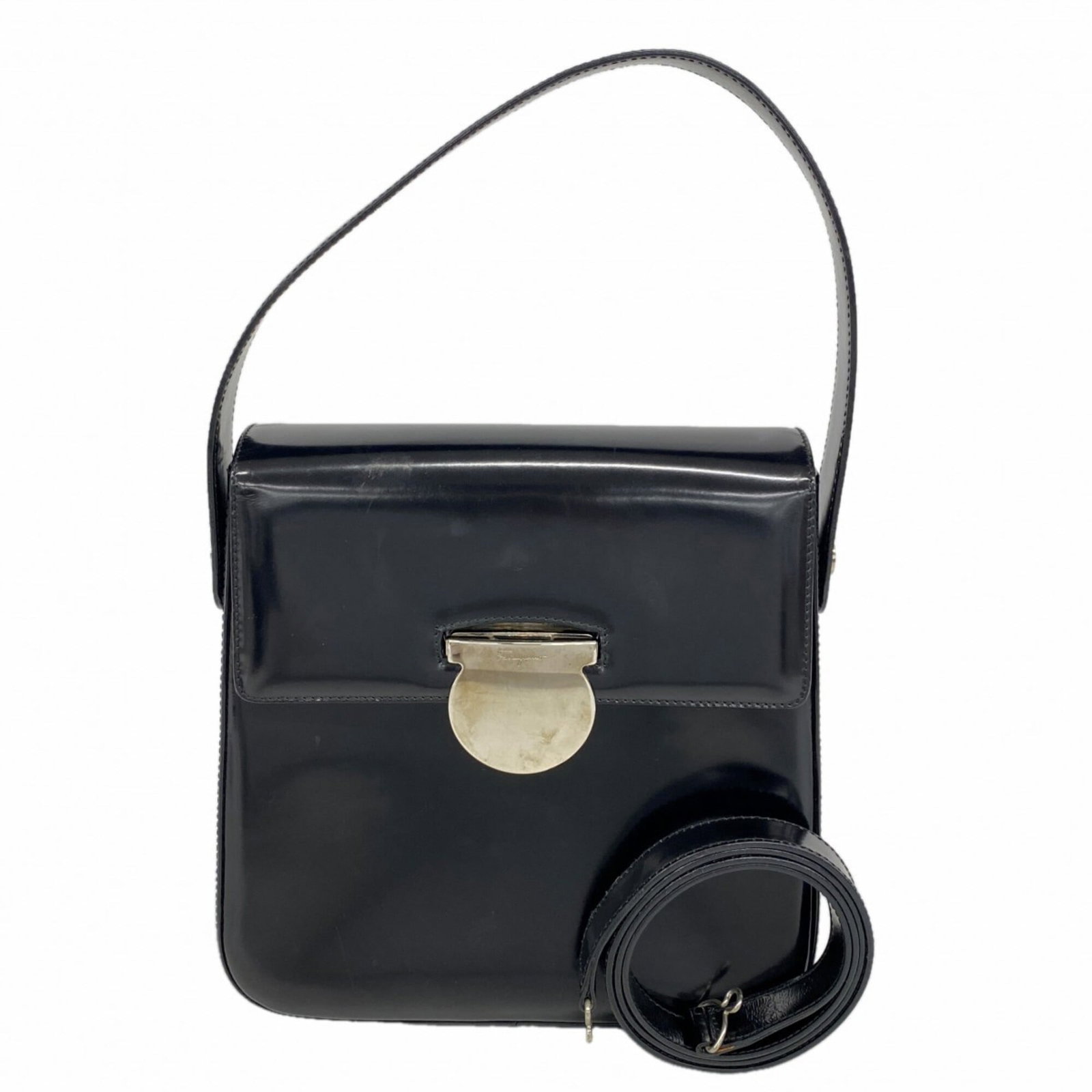 Handbag by Salvatore Ferragamo: Handbag by Salvatore Ferragamo Black leather handbag by Salvatore Ferragamo, featuring silver hardware and dimensions of 22cm x 21cm x 7.5cm. This sleek and sophisticated accessory boasts a classic de