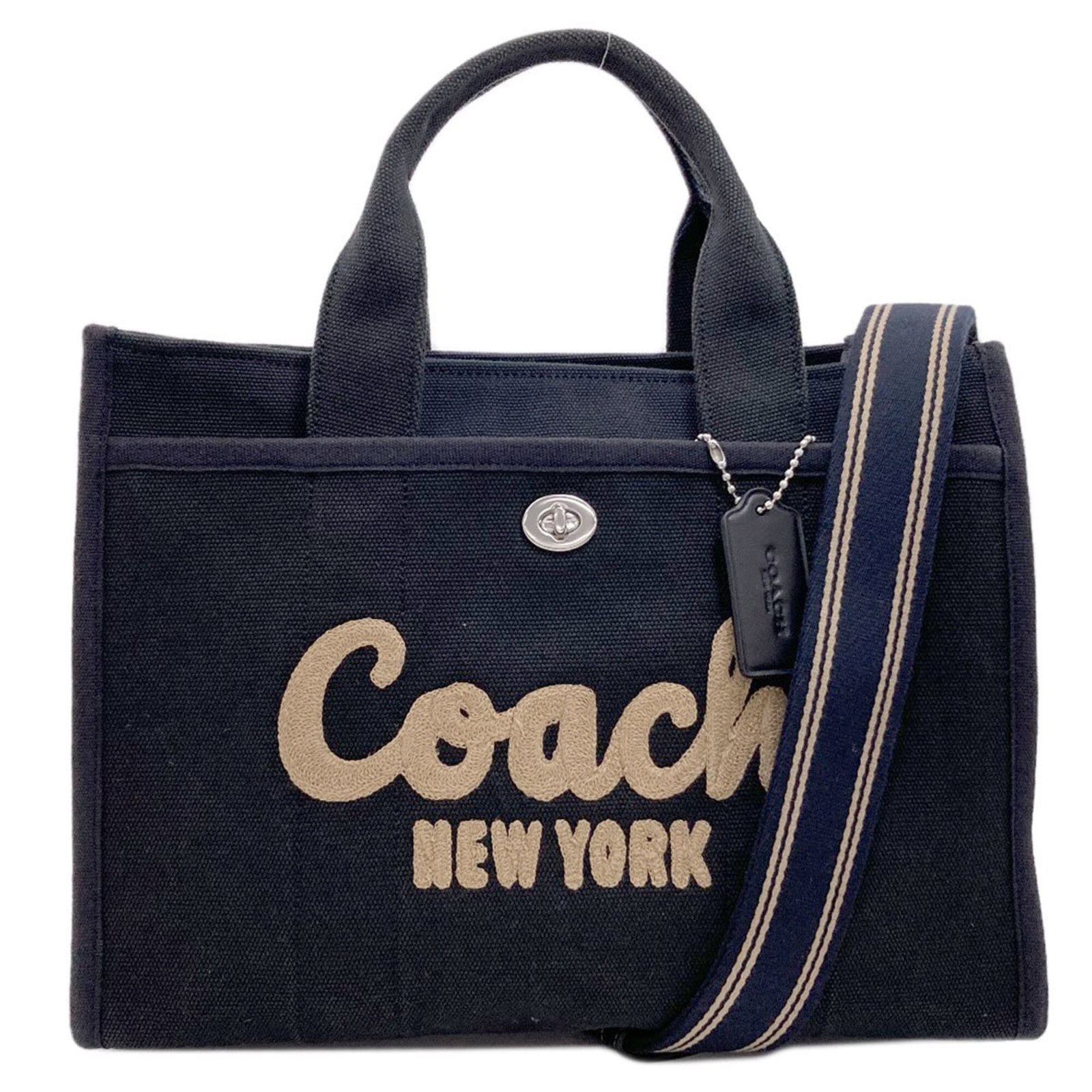 Handbag Canvas Coach: Handbag Canvas Coach Canvas Coach handbag in black, featuring a zipper closure and outer pocket with turn lock. The bag has multiple pockets for organization, including a snap pocket on one side. Meas