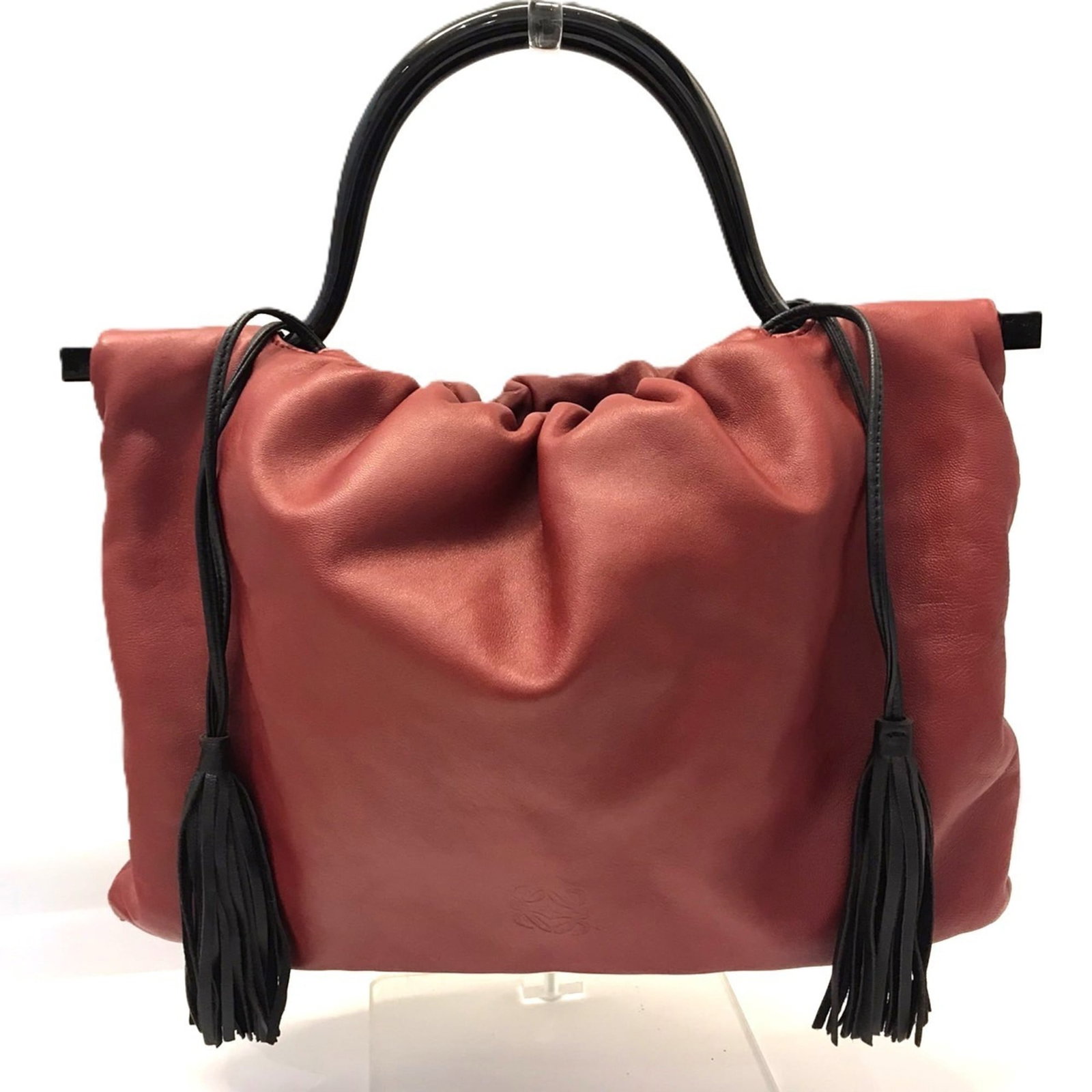 Handbag Leather from Loewe: Handbag Leather from Loewe This stunning handbag from Loewe boasts a striking red leather exterior, measuring 22cm x 32cm x 3cm. Its sleek design and compact size make it a versatile accessory for eve