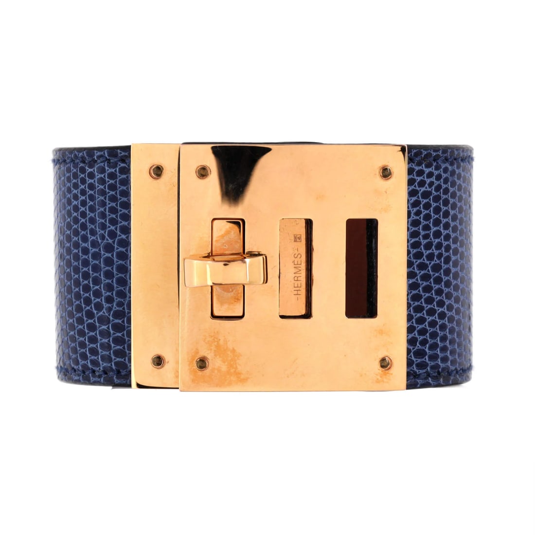 Lizard dog bracelet Kelly Hermes: Lizard dog bracelet Kelly Hermes Blue lizard exterior with gold accents, paired with neutral brown leather interior, the Kelly Dog Bracelet by Hermes features an eye-catching design. Measuring 6.5"