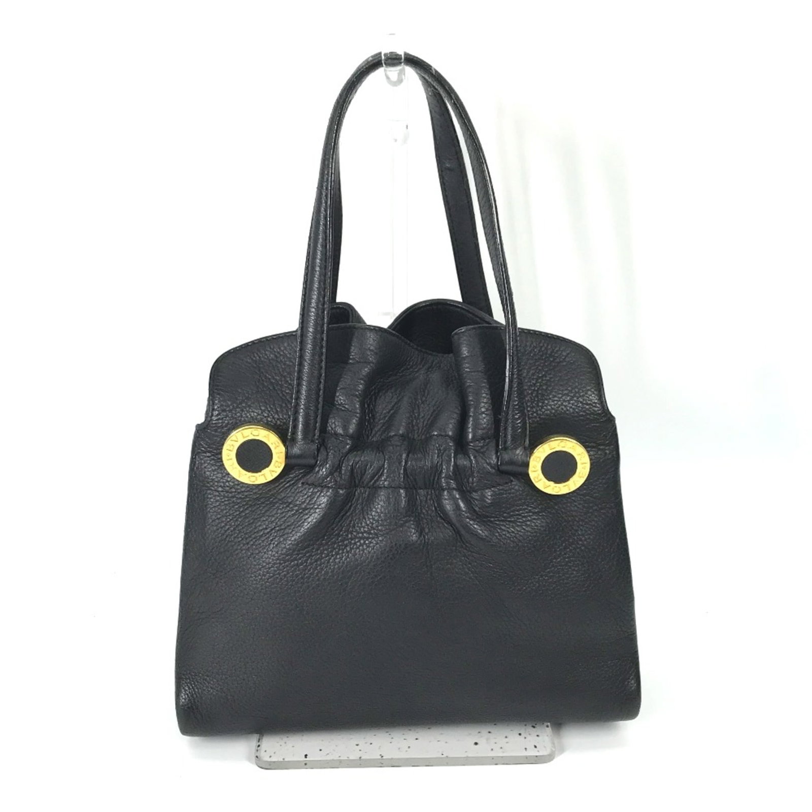 Bvlgari Tote Bag Leather: Bvlgari Tote Bag Leather Black leather Bvlgari tote bag with classic design, measuring 23cm wide x 19.5cm high x 8.5cm deep. The bag features a timeless style and elegant proportions, making it a vers