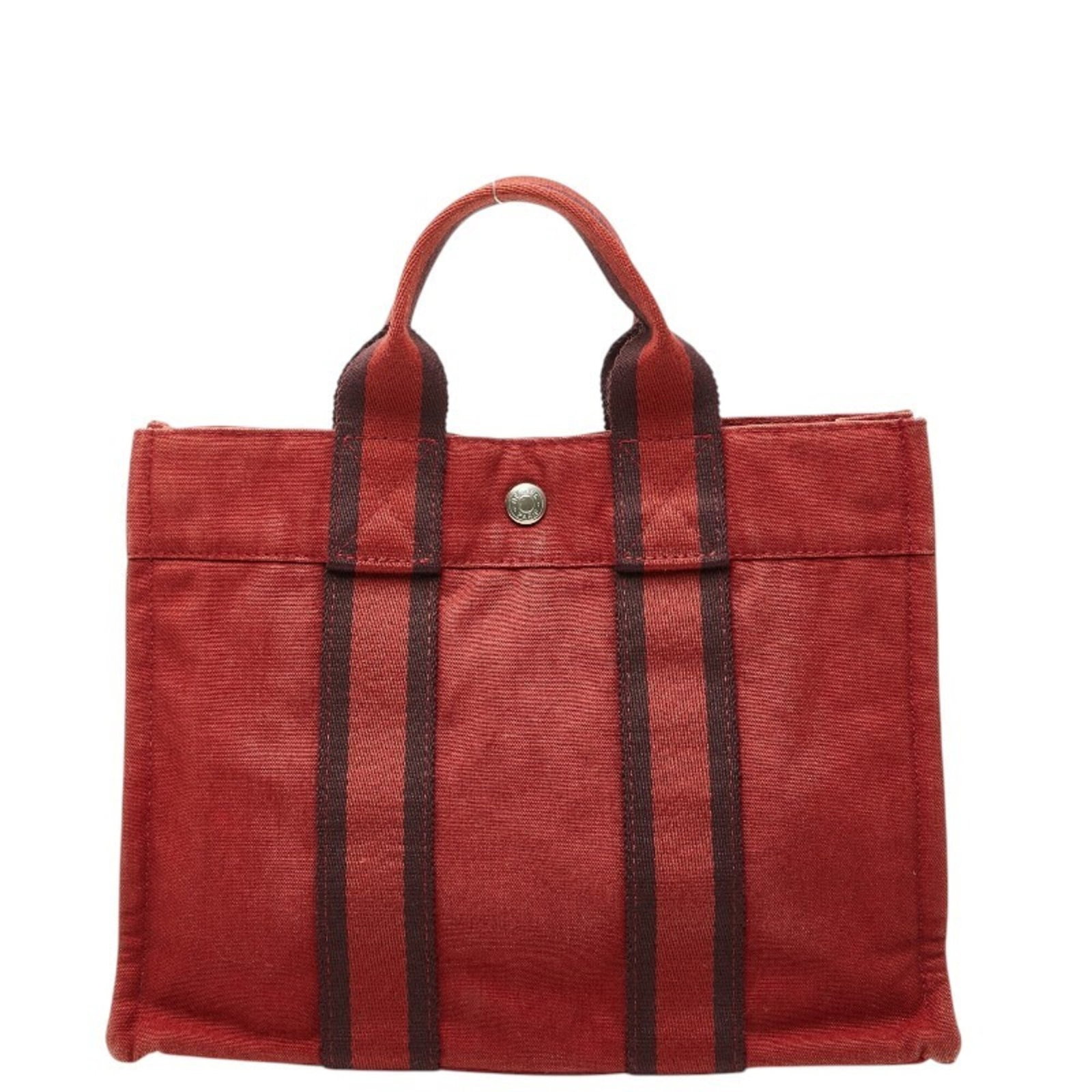Handbag Hermes Tote Canvas: Handbag Hermes Tote Canvas Canvas Red Hermes Tote Bag, 22cm x 30cm x 8cm. This vibrant red canvas tote bag from iconic brand Hermes boasts a classic design and durable construction. With its timeless