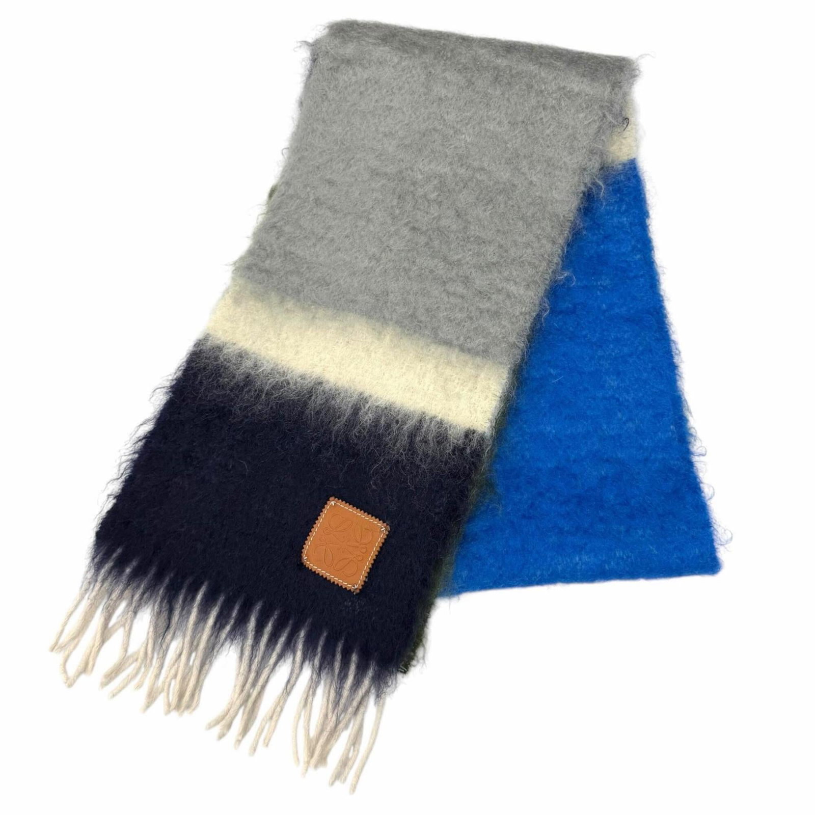 Stole Mohair Wool Nylon Loewe: Stole Mohair Wool Nylon Loewe Stole from renowned Spanish fashion house Loewe, this vibrant multi-color stole combines the luxurious textures of mohair, wool, and nylon. Measuring 1.9m x 23cm, it boas