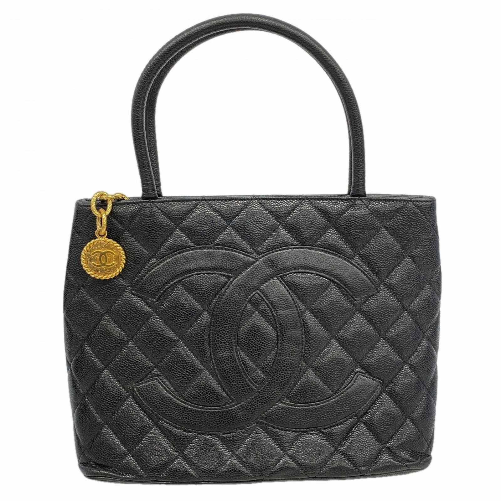 Chanel Tote Bag Grained Calfskin: Chanel Tote Bag Grained Calfskin Grained Calfskin Chanel Tote Bag in Black. This classic tote bag features a timeless design with a rich, grained calfskin material and gold hardware. Its sleek black c