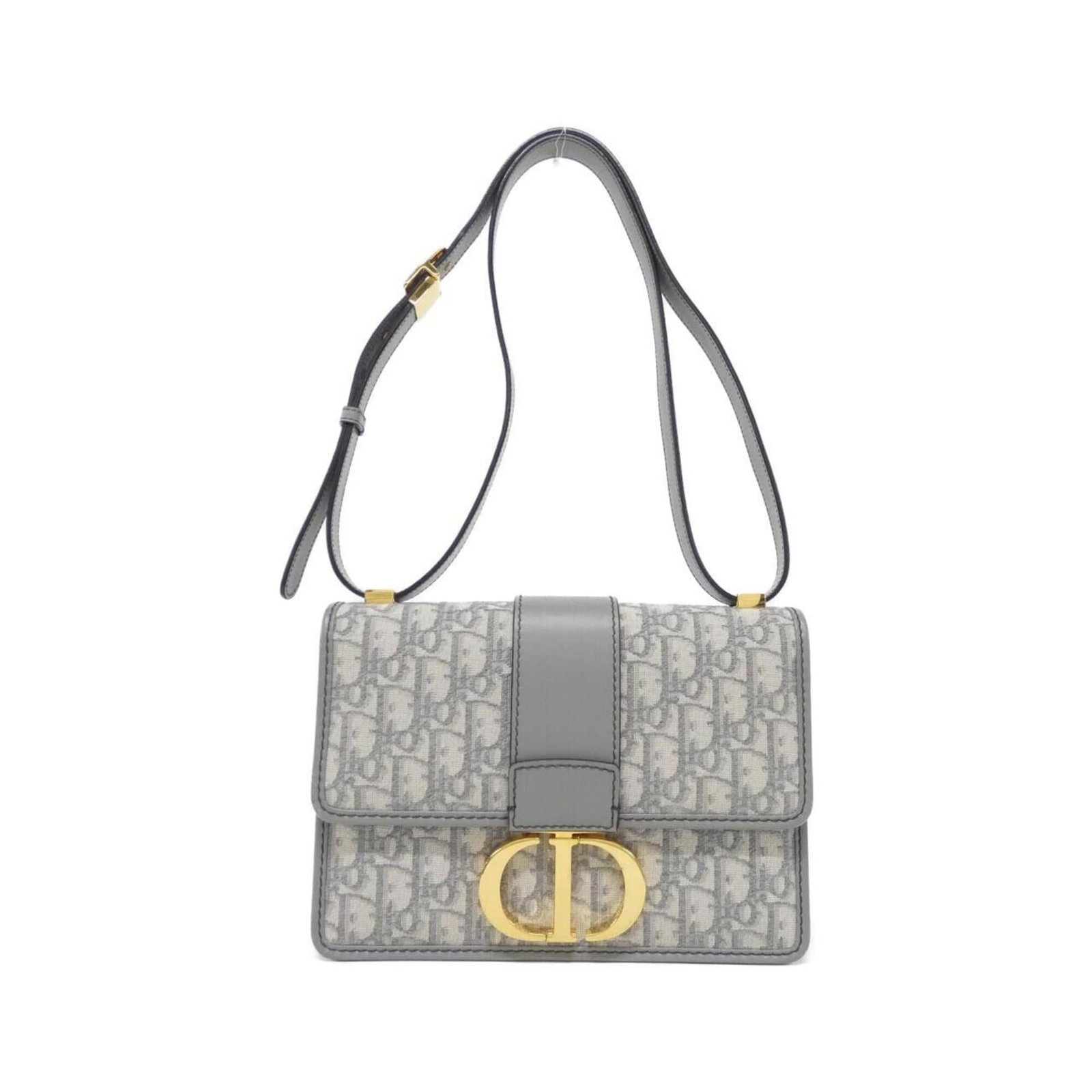 Shoulder Bag By Christian Dior: Shoulder Bag By Christian Dior The Christian Dior shoulder bag boasts sleek, gray canvas construction and elegant gold hardware for a sophisticated look. With adjustable straps spanning 26.37'' to 44.