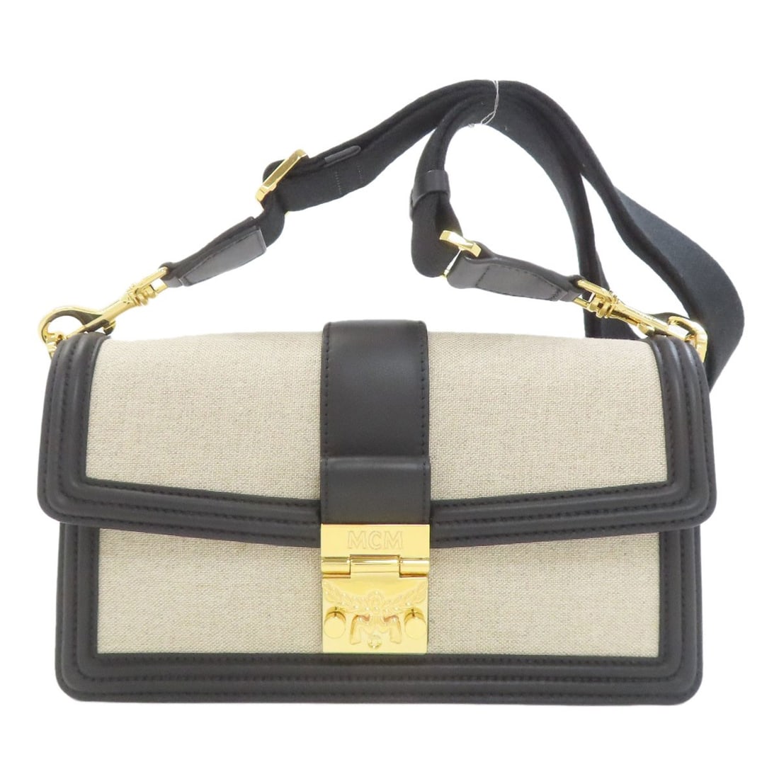 Canvas Leather tote bag hardware Mcm logo: Canvas Leather tote bag hardware Mcm logo Beige canvas tote bag with MCM logo hardware. Made from high-quality canvas, this stylish tote features a classic design and a distinctive logo detail. The be