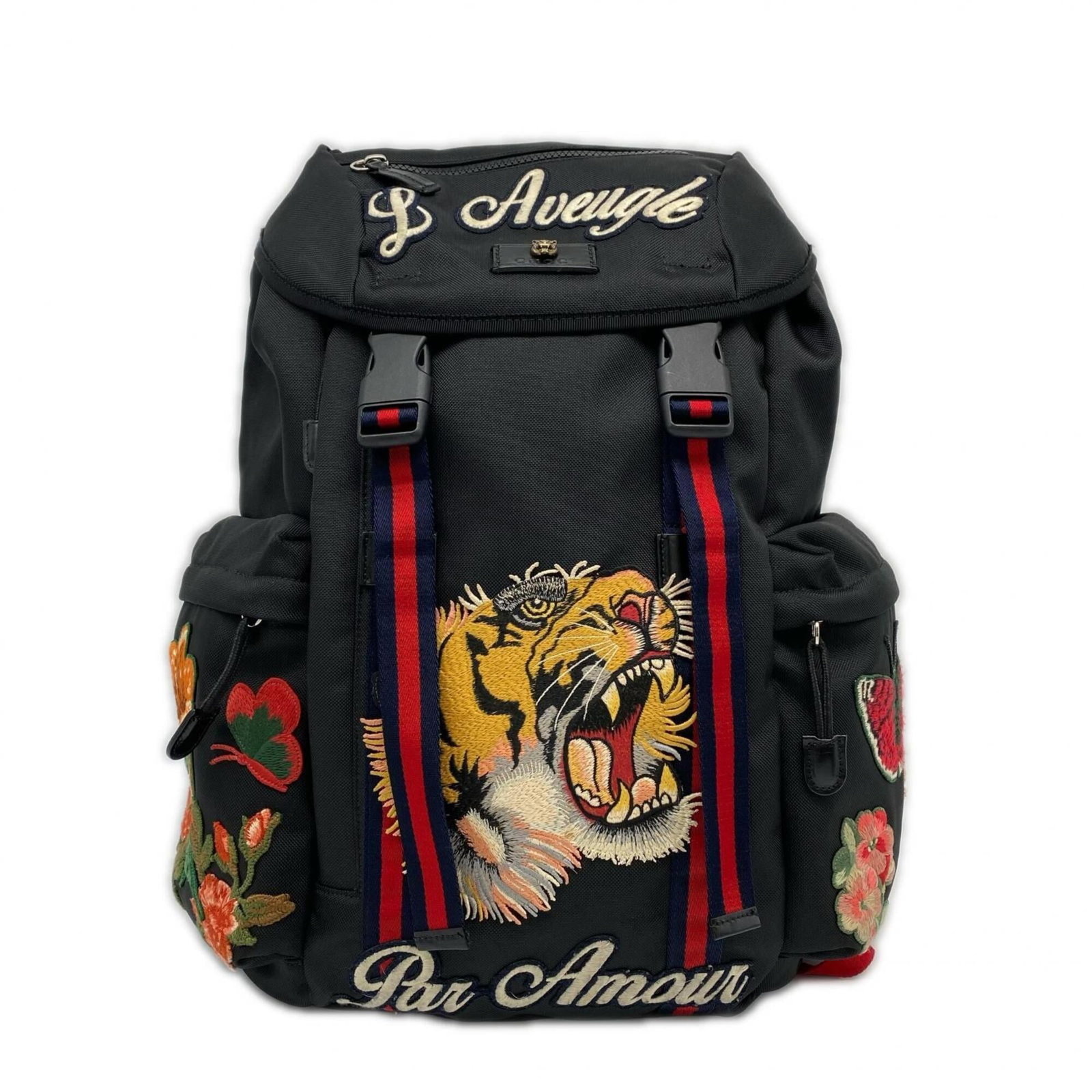 Nylon backpack by Gucci: Nylon backpack by Gucci Gucci's nylon backpack boasts a sleek black and multi-color design, featuring a sturdy buckle closure. Measuring 44cm x 32cm x 9cm, the bag has adjustable strap length to fit