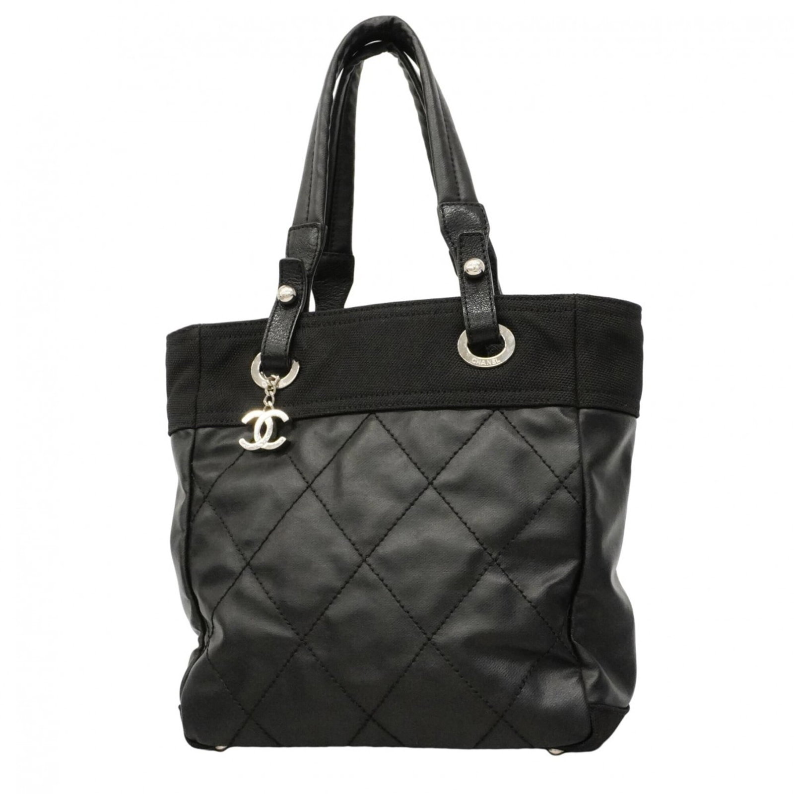 Canvas tote bag by Chanel: Canvas tote bag by Chanel Canvas tote bag by Chanel, featuring black canvas material and silver hardware. This stylish tote measures 27.5cm x 24.5cm x 10cm, making it a compact yet spacious accessory 