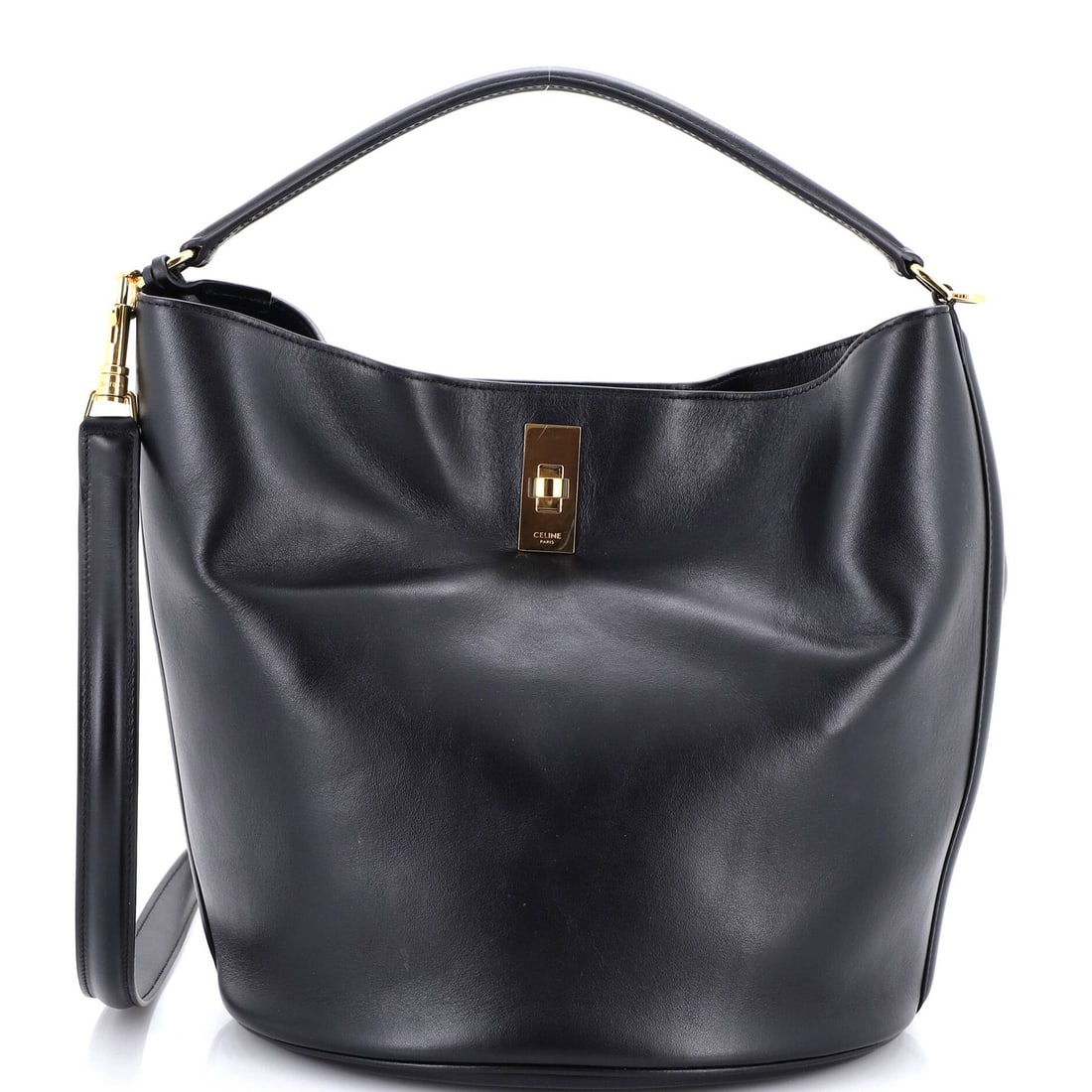 Celine Bucket 16 Bag Leather: Celine Bucket 16 Bag Leather Black Celine Bucket 16 Bag Leather features scuffs, minor creases, and edge wear on its exterior, with handles showing minor cracking and scuffs. The bag comes with a