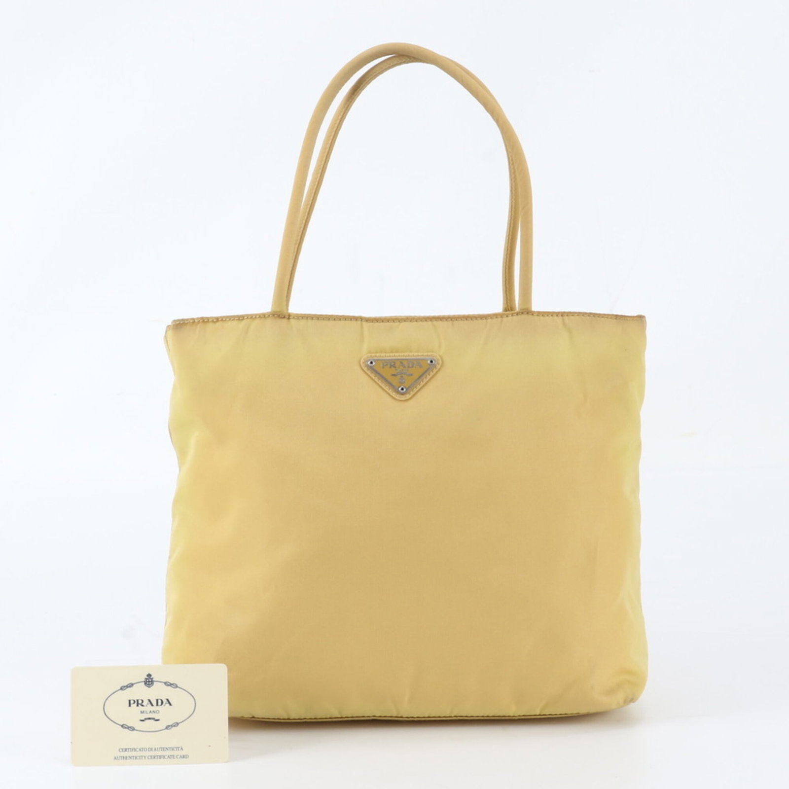 Tessuto tote bag Prada handbag: Tessuto tote bag Prada handbag Tessuto tote bag from Prada, featuring a vibrant yellow color and structured design. Made in Italy, this handbag boasts a sleek 21cm x 26cm x 8cm size and a 40cm long ha
