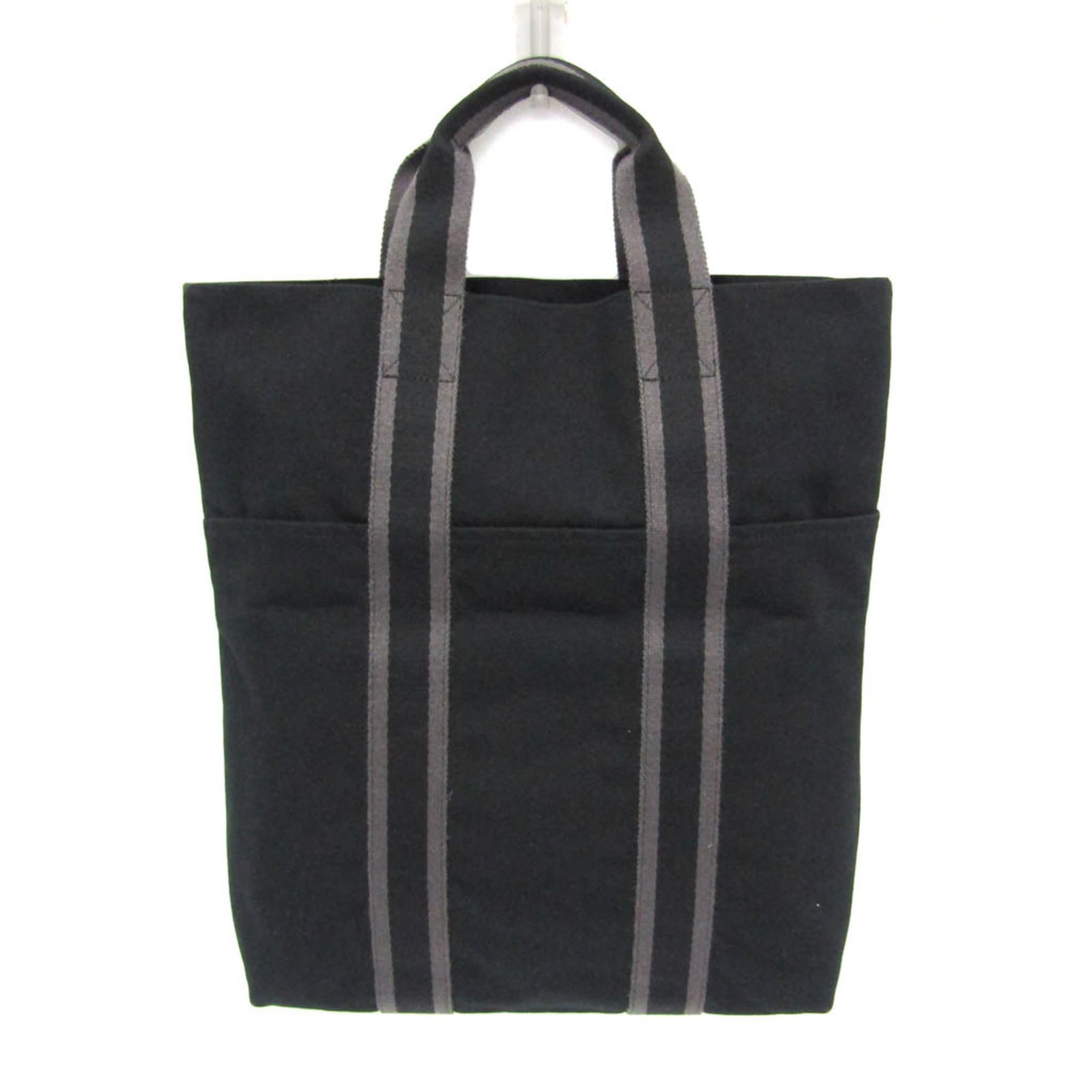 Hermes Tote Bag Cotton Canvas: Hermes Tote Bag Cotton Canvas Black cotton canvas tote bag from Hermes, featuring an open pocket and inner pocket for organization. Made in France with a classic design that exudes timeless elegance. 