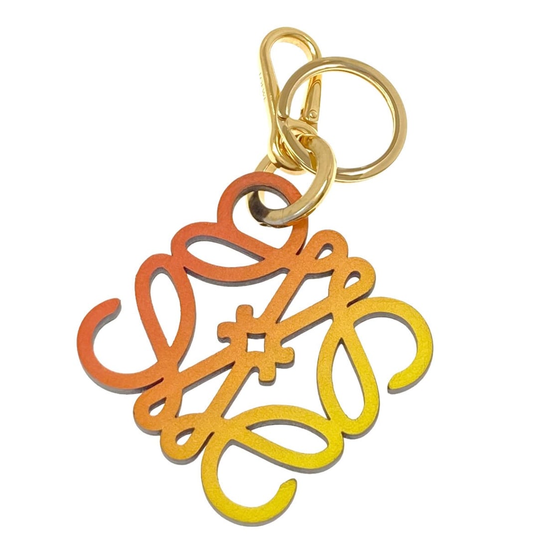 Loewe ring leather key anagram: Loewe ring leather key anagram Brown leather key ring with a distinctive anagram design. This unique accessory features a clever combination of letters and shapes, adding a touch of personality to any