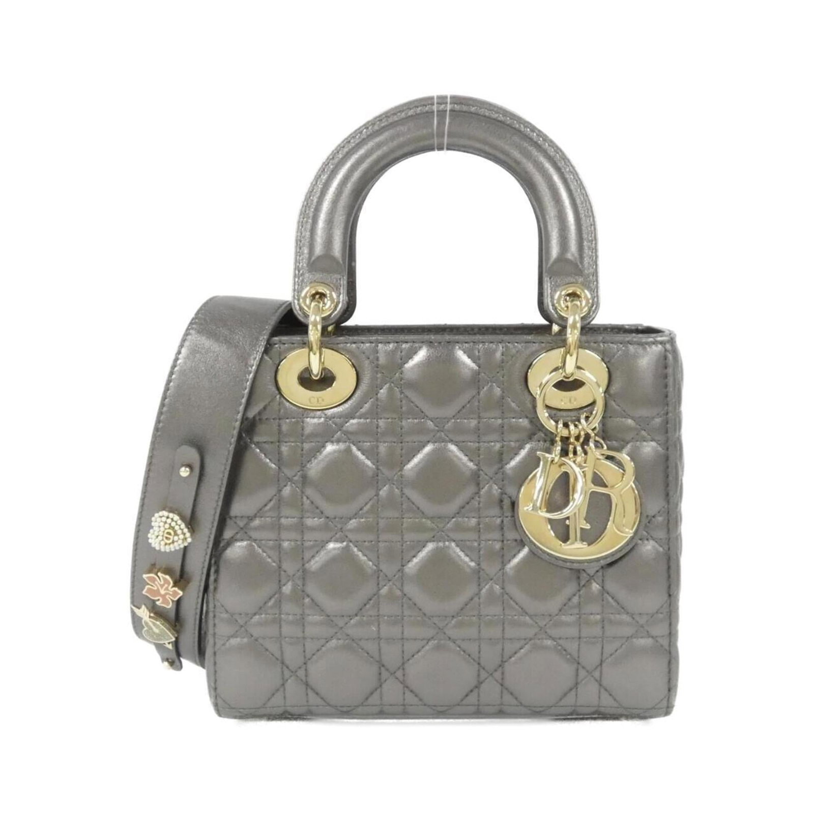 Handbag Christian Dior Leather: Handbag Christian Dior Leather The Christian Dior leather handbag boasts sleek, modern lines and a sophisticated color palette featuring gray, gunmetal, and metallic hardware. Crafted from high-qualit