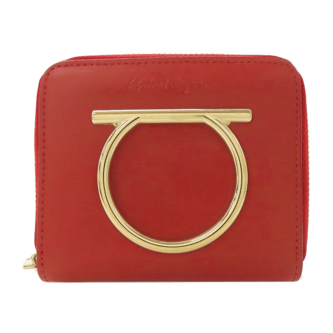 Salvatore Ferragamo Gancinihardware Bifold Wallet With Coin Pocket Leather: Salvatore Ferragamo Gancinihardware Bifold Wallet With Coin Pocket Leather Red leather bifold wallet with coin pocket, featuring the iconic Gancini hardware from Salvatore Ferragamo. This classic desi
