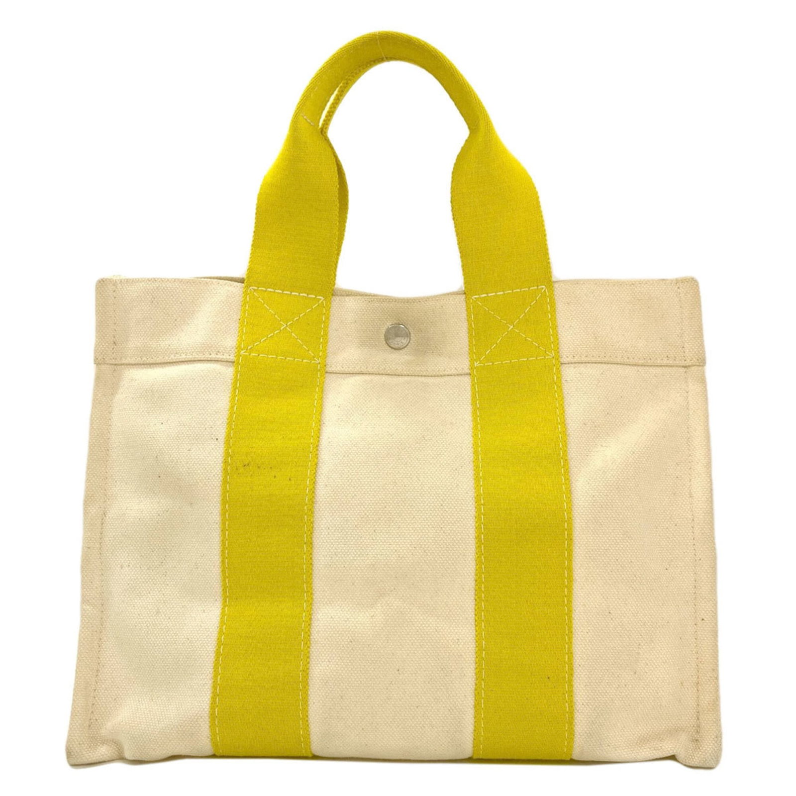 Handbag Canvas by Hermes: Handbag Canvas by Hermes Canvas handbag from iconic luxury brand Hermes, boasting vibrant yellow color and classic design. Measuring 27cm x 34cm x 19cm, this stylish accessory is a testament to the ti