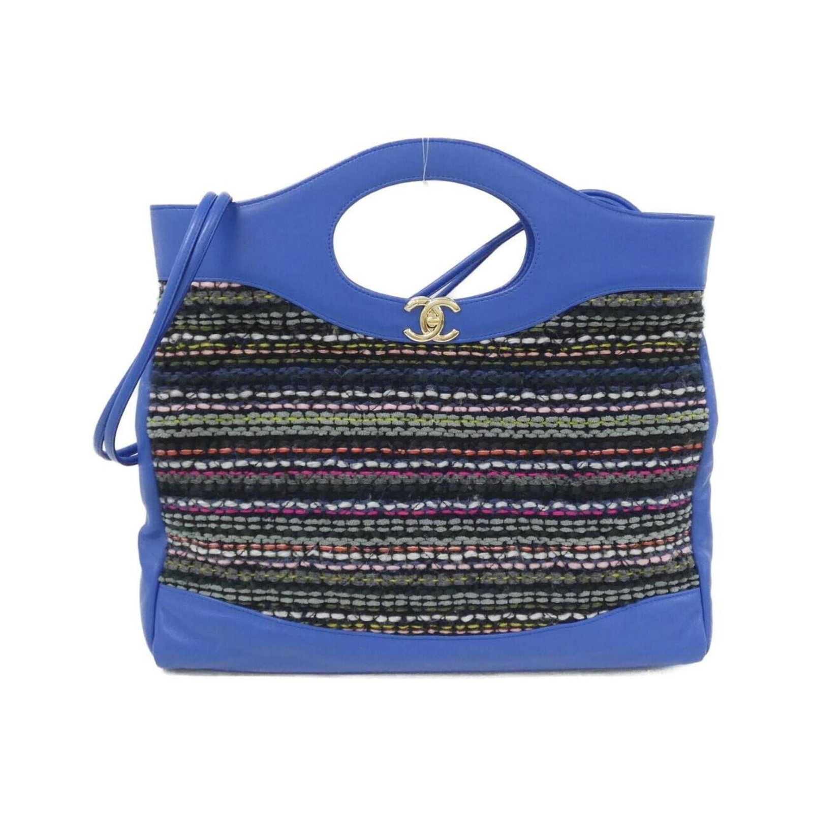 Tweed leather handbag by Chanel: Tweed leather handbag by Chanel Tweed leather handbag by Chanel boasts a unique blend of tweed and leather, with a distinctive blue and multi-color design. The elegant gold hardware adds a touch of so