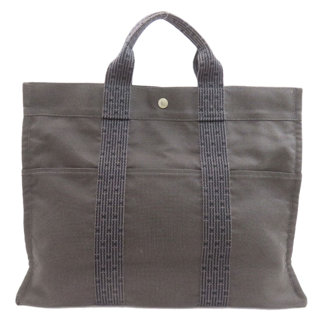 Hermes Her Linemm Handbag Canvas: Hermes Her Linemm Handbag Canvas Gray canvas handbag from HERMES featuring a timeless design. The bag's exterior color and material make it a versatile accessory for everyday use. Its classic style