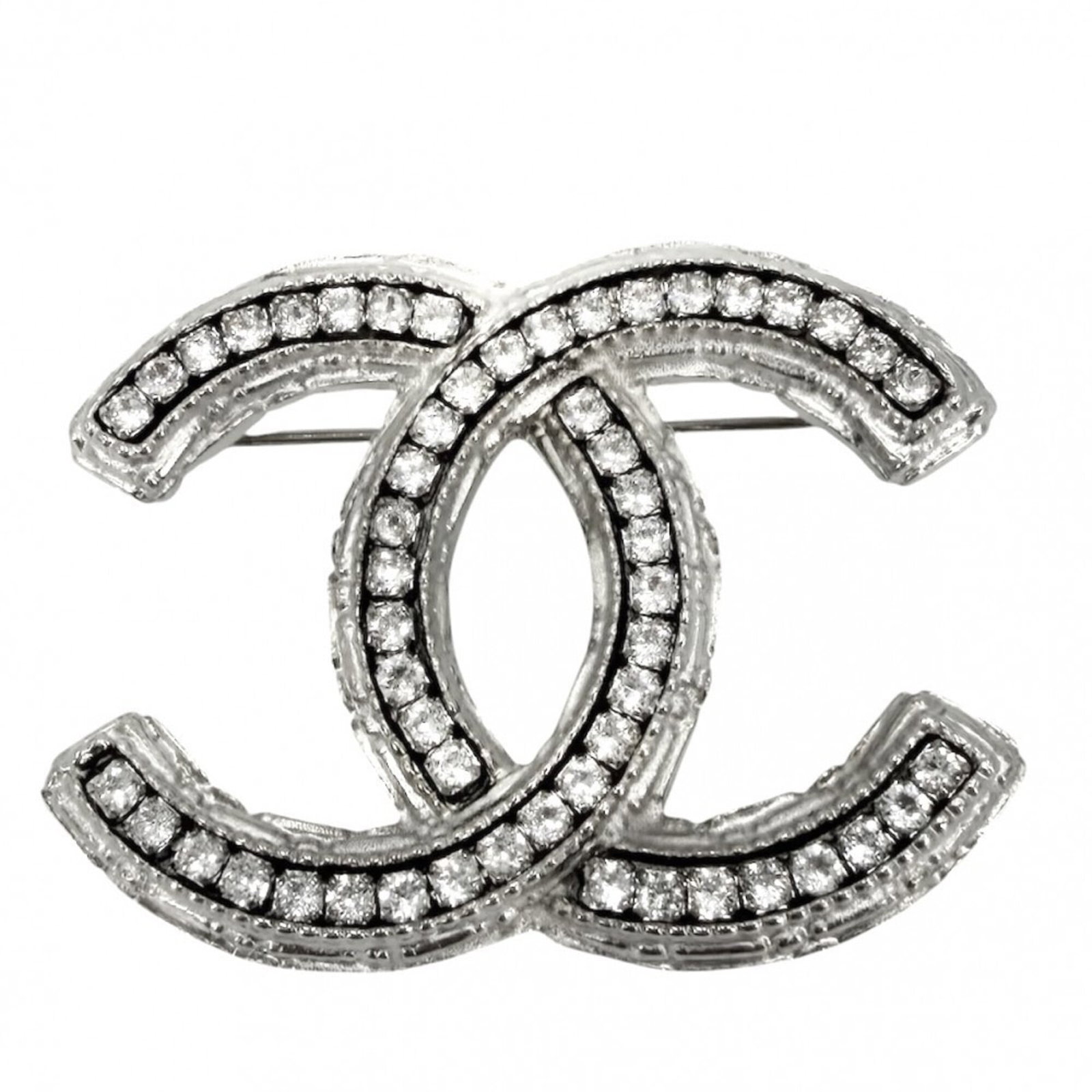 Rhinestone Brooch by Chanel: Rhinestone Brooch by Chanel Rhinestone Brooch by Chanel boasts intricate details with its silver rhinestones, adding a touch of glamour to any outfit. Measuring 3.3cm x 4.5cm x 0.15'' in size, this br