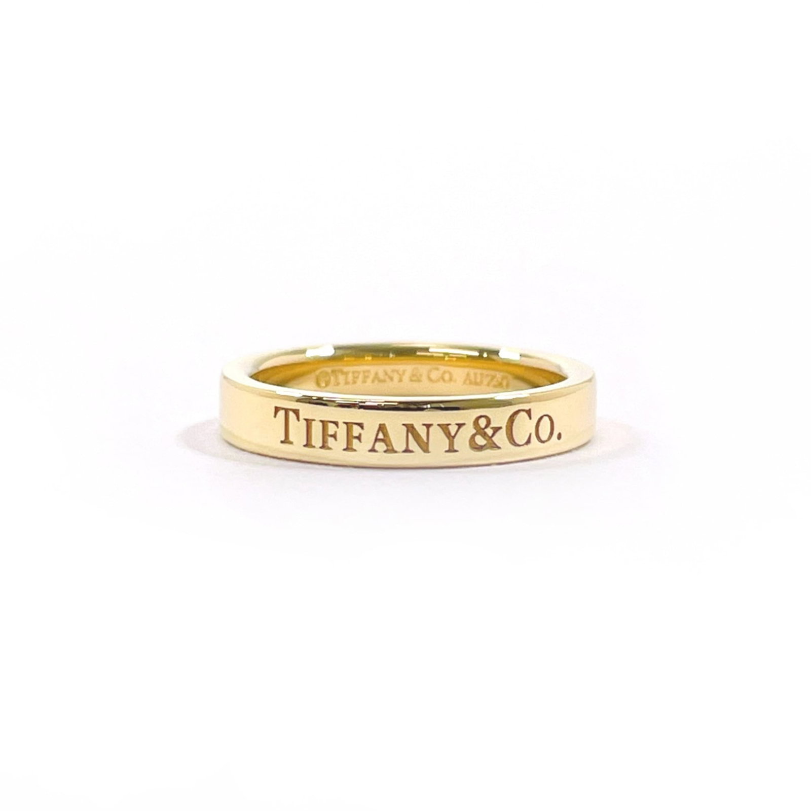 Yellow Gold 18K Tiffany Band Ring: Yellow Gold 18K Tiffany Band Ring Yellow gold (18K) band ring from Tiffany, available in US size 2.5, featuring the brand's signature style with a classic design that suits women's fashion. This 18K y