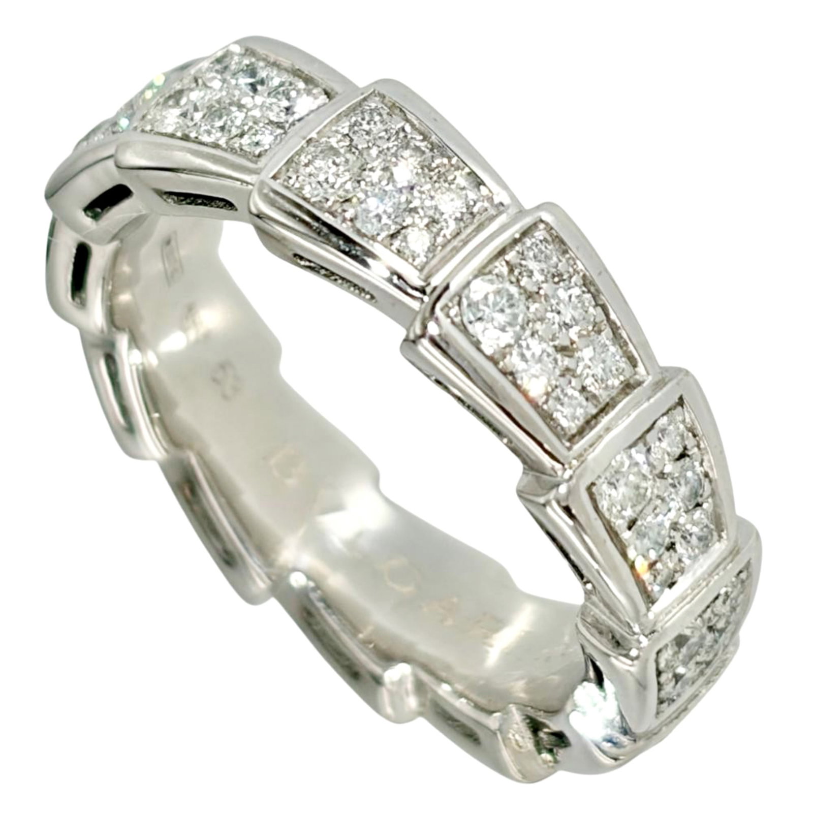 White Gold Bvlgari Ring Band: White Gold Bvlgari Ring Band White gold (18K) band ring from Bvlgari's Serpenti line, crafted in Italy. This elegant ring features a sleek design with the iconic Serpenti motif, showcasing the luxury 